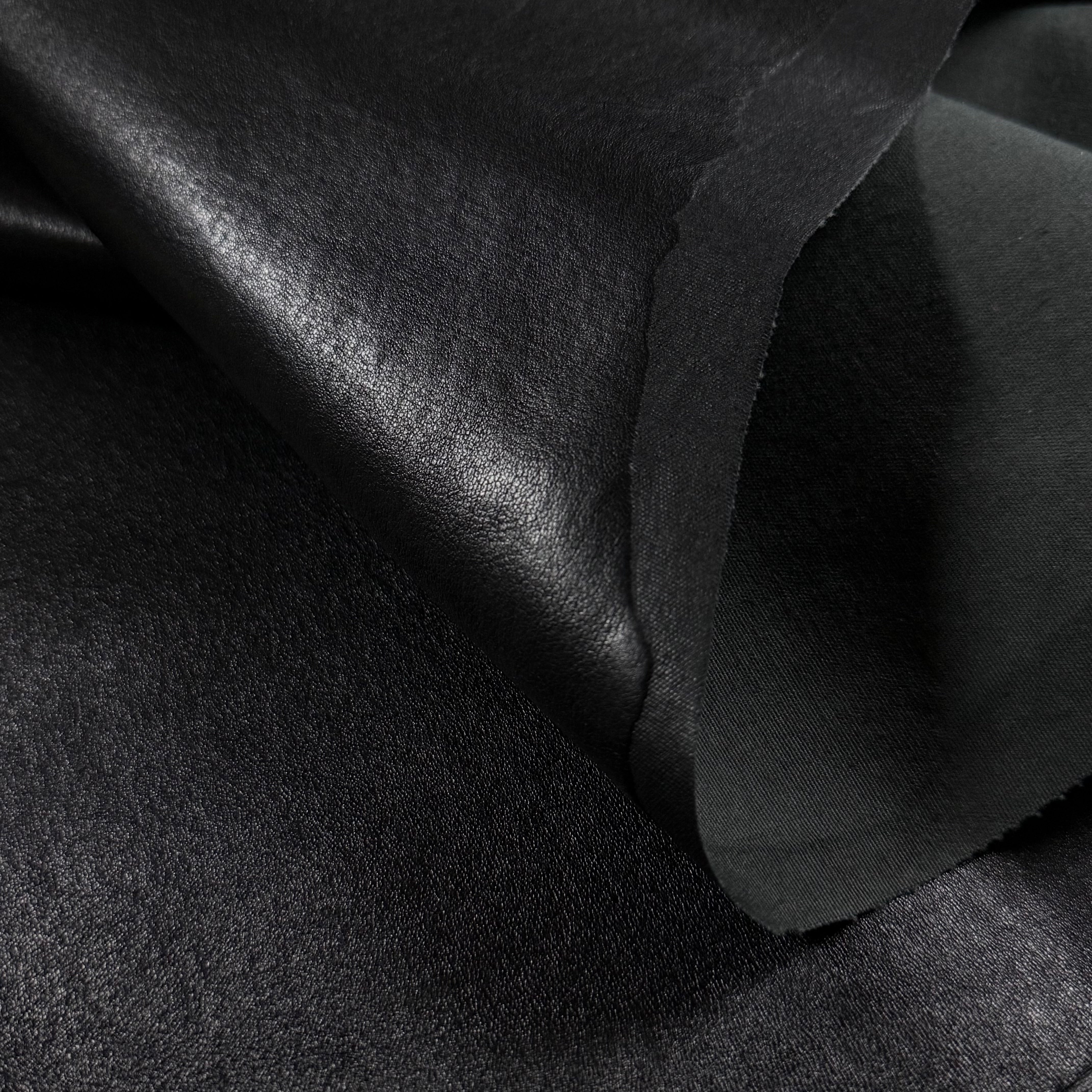 Black Italian stretch Nappa lamb leather with a smooth, semi-aniline finish and lycra backing.