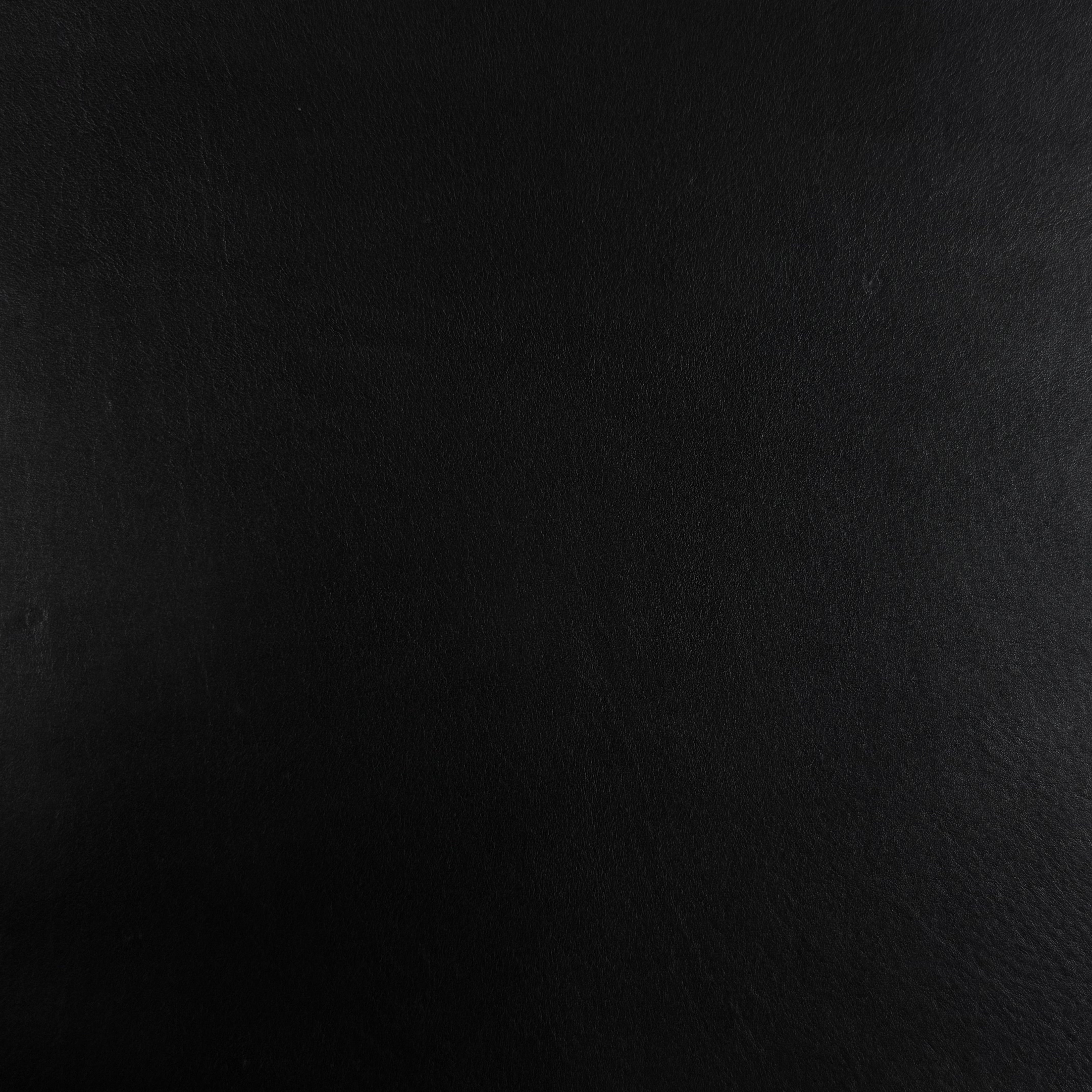 Smooth black vegetable tanned baby calf leather with a subtle texture.