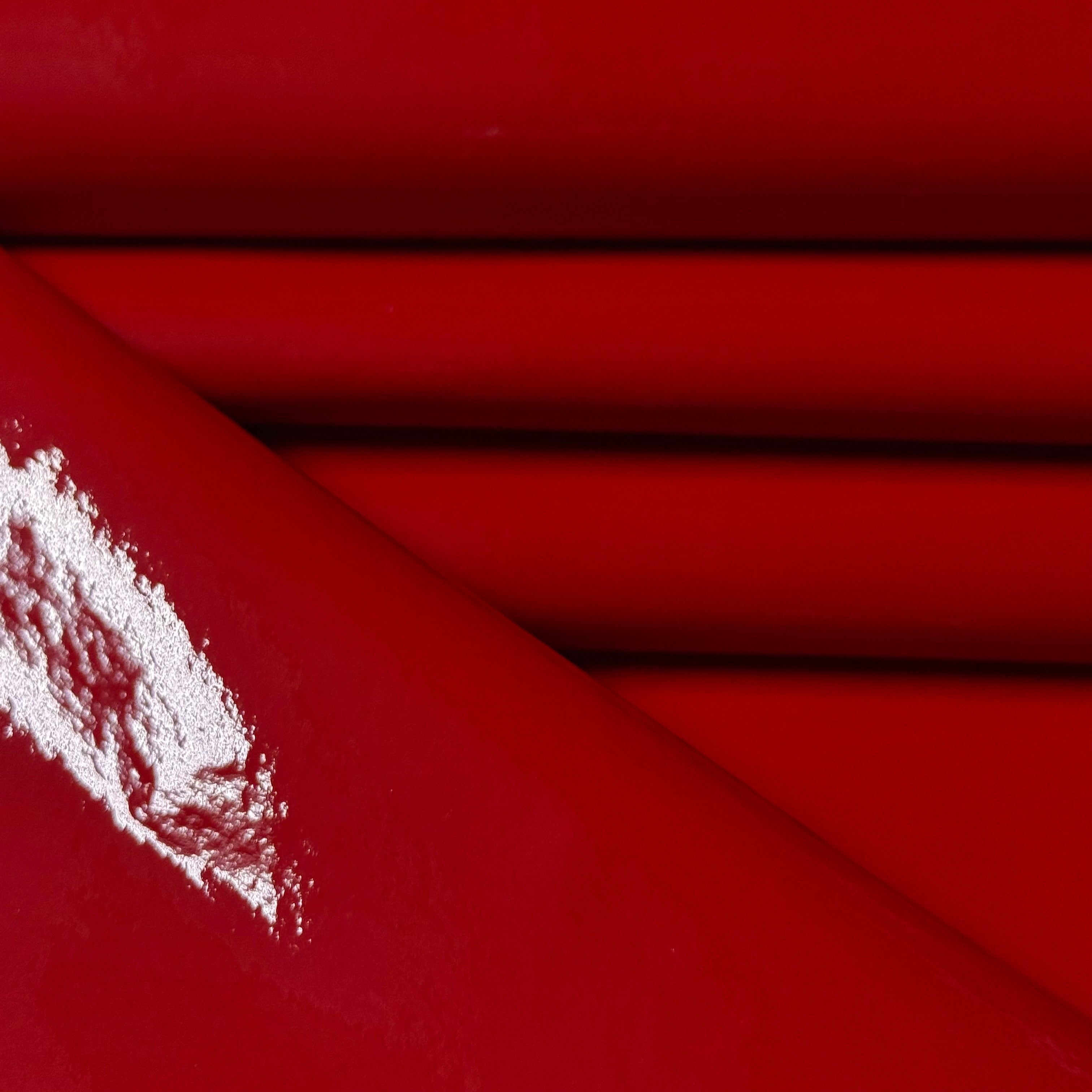 Red Patent Pig leather, 1-2 oz, featuring a high-gloss, reflective finish with a smooth, folded texture.