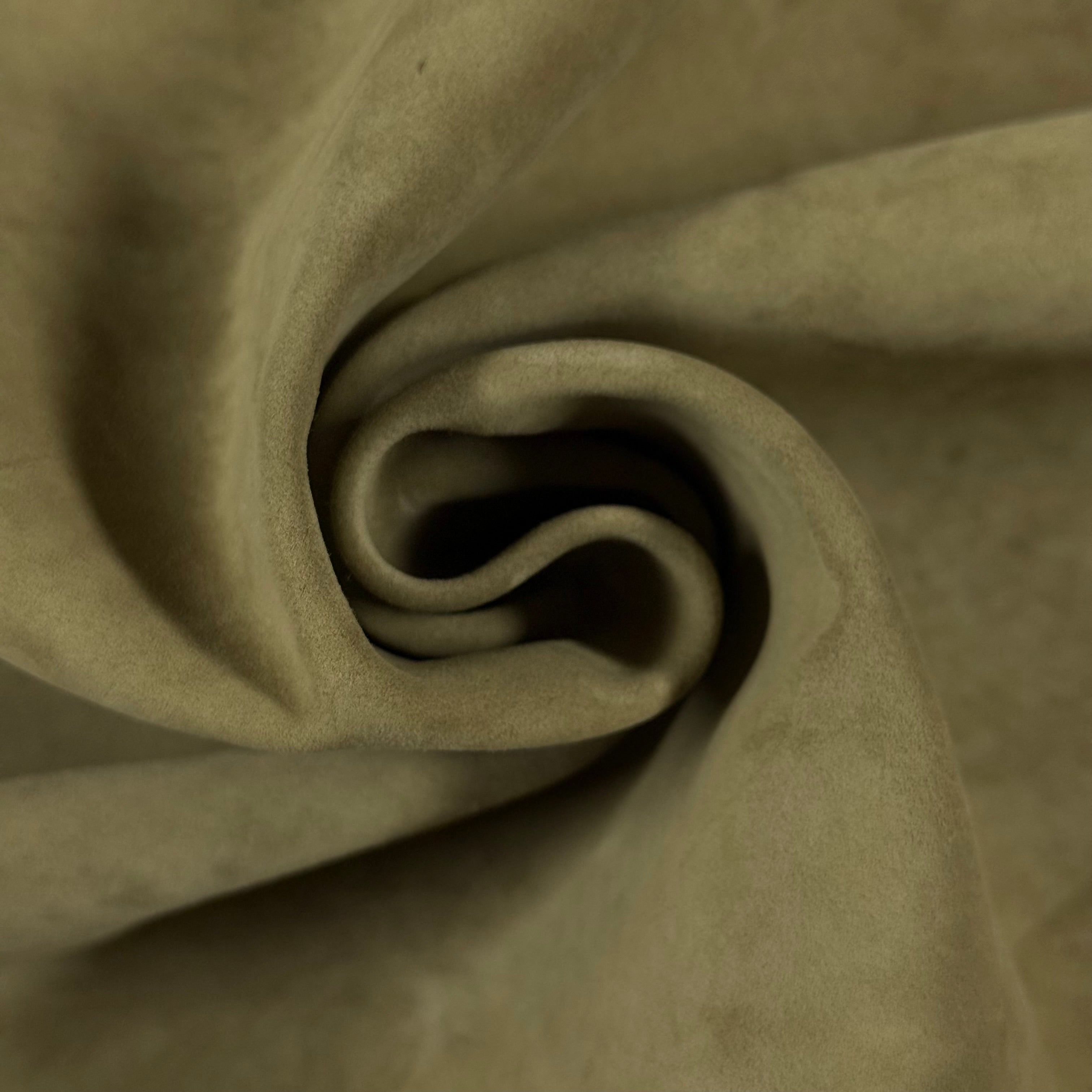 Soft, olive green Conceria Incas Italian Water Calf leather with a suede-like finish, folded in a spiral.