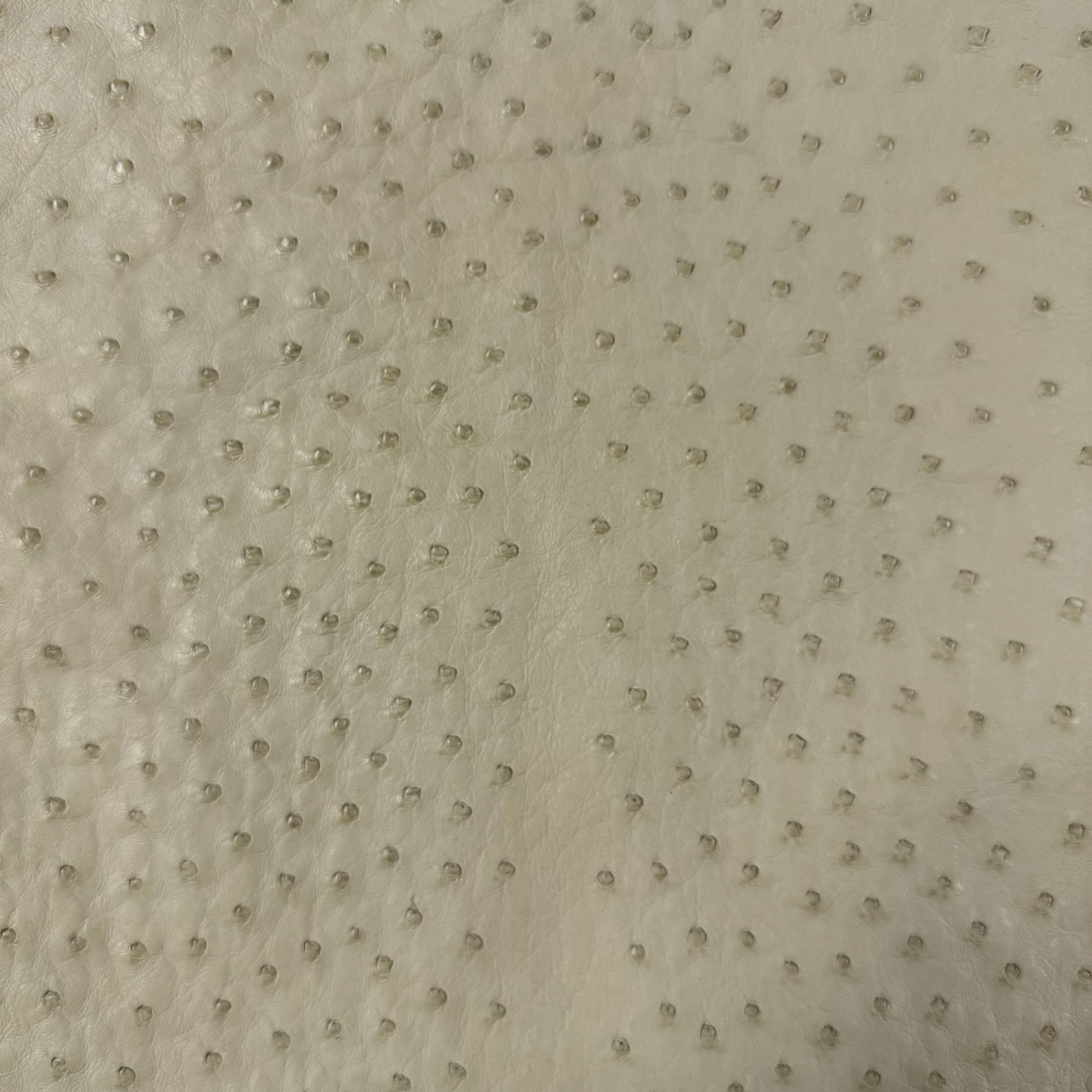 Close-up of full quill genuine ostrich leather in a light, earthy tone, showcasing its distinctive raised quill pattern.