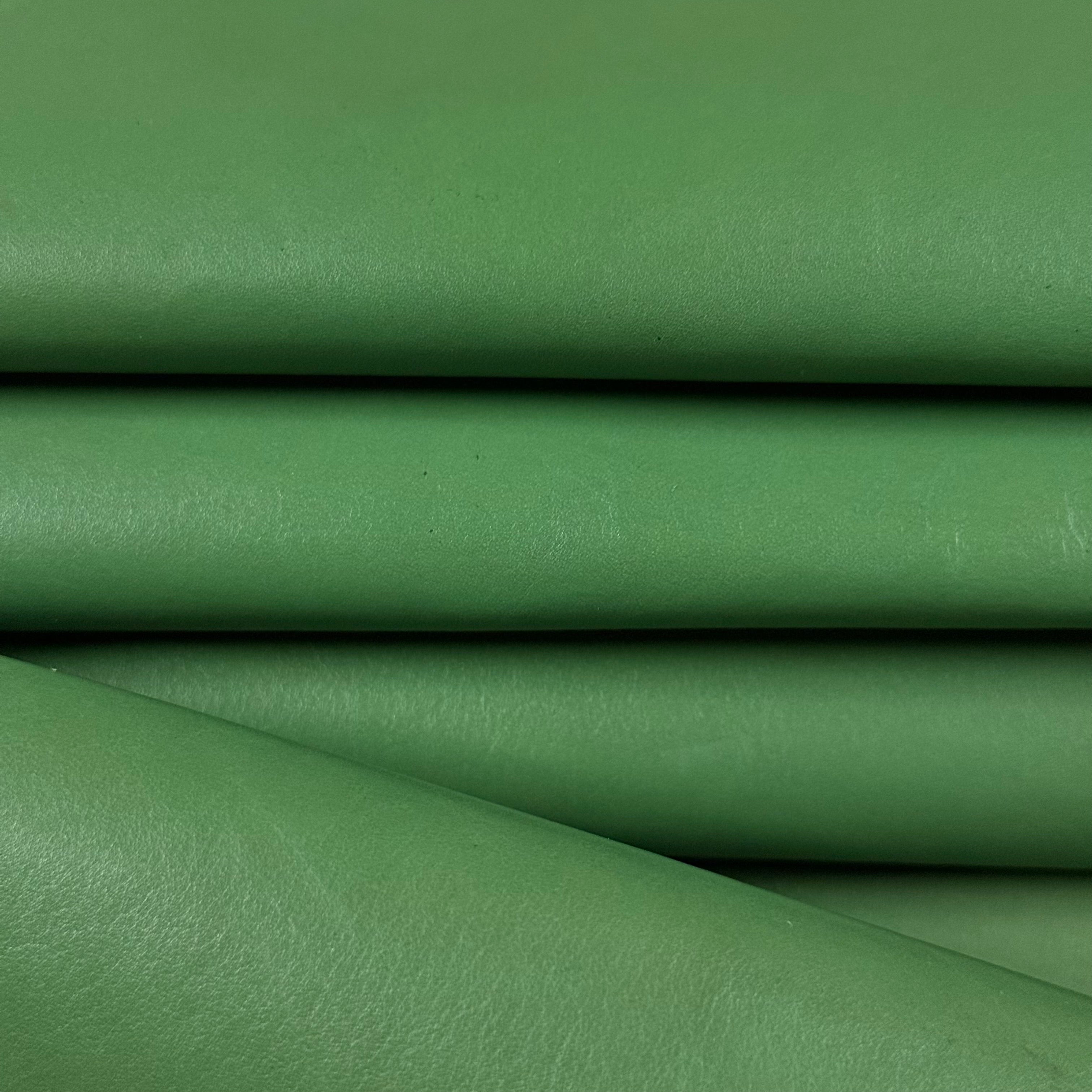 Smooth vegetable-tanned baby calf leather in a vibrant green, folded to show its polished surface.