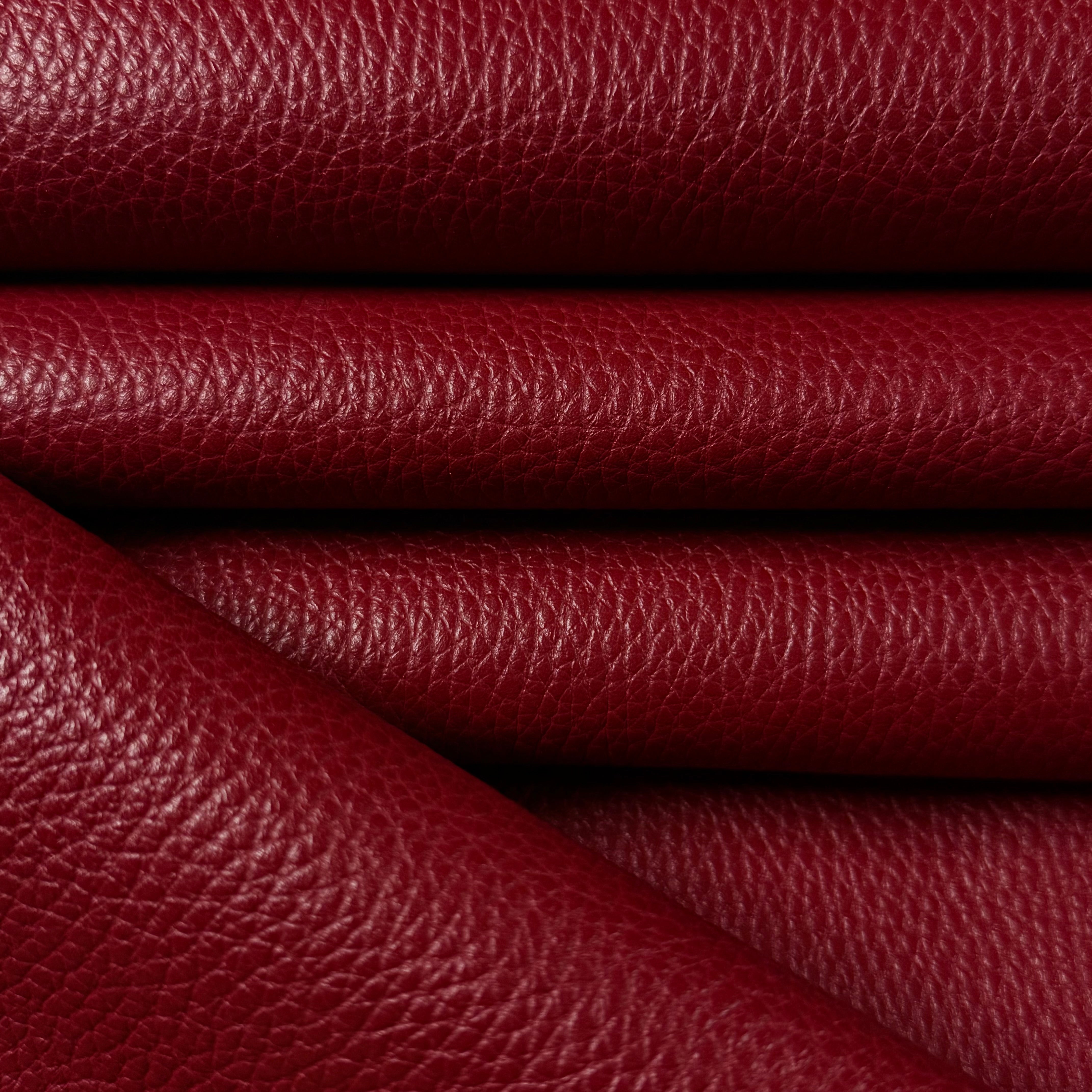 Deep red Pebble Grain Calf leather, 3-4 oz weight, featuring a rich, textured surface with elegant folds.