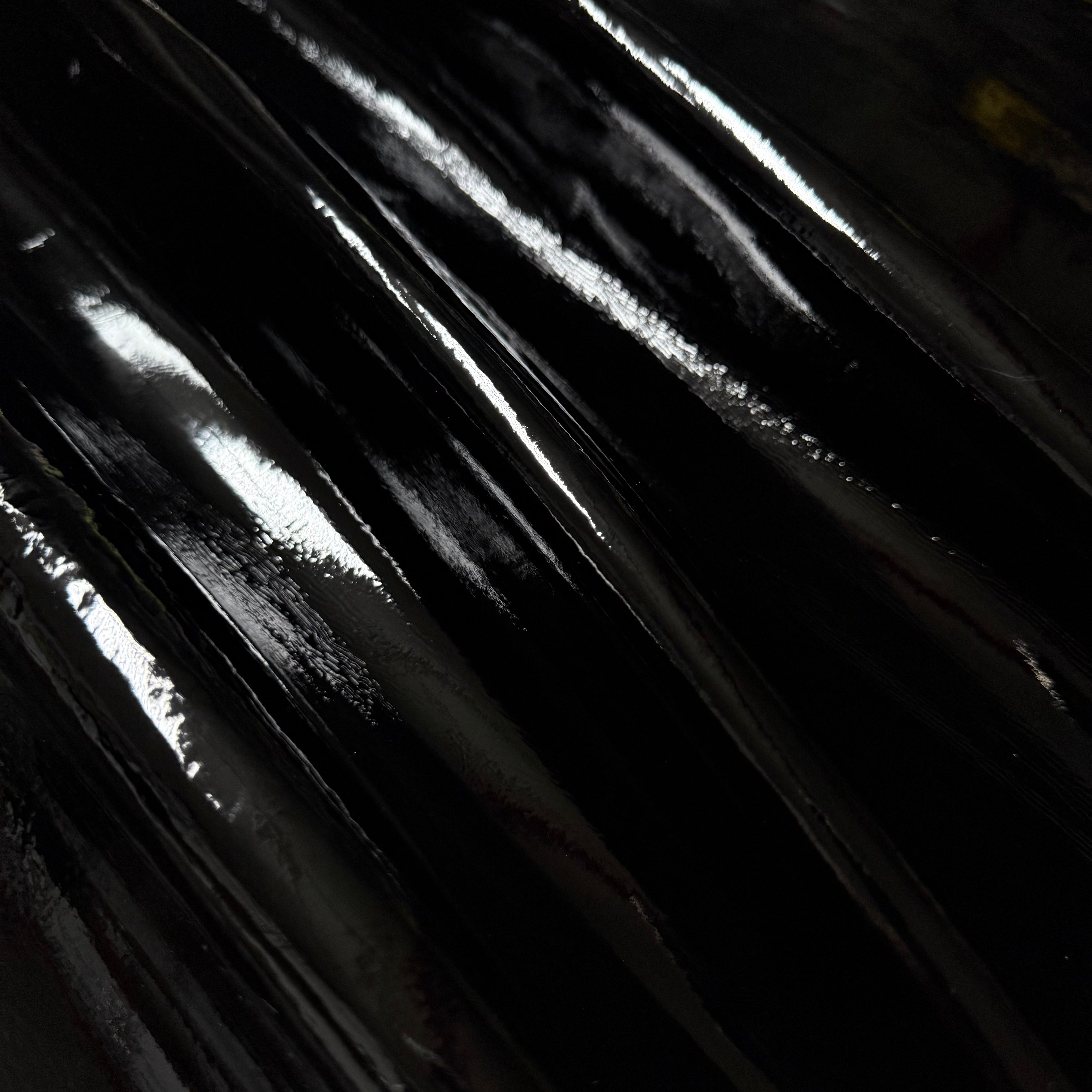 Patent Pig 1-2 oz in black, featuring a high-gloss, reflective patent leather texture with smooth, flowing folds.