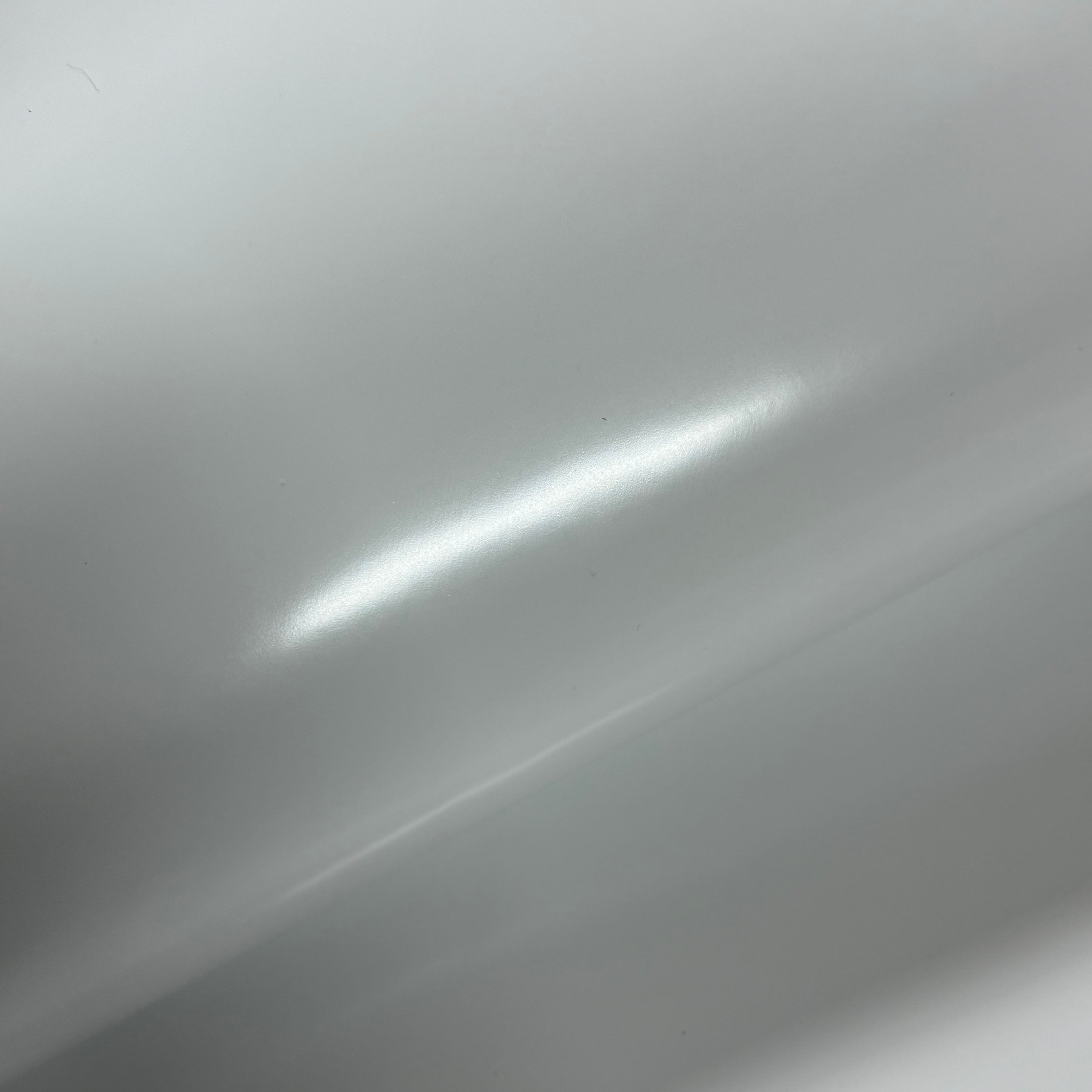 Smooth polished white cowhide leather with a high-gloss, reflective finish.