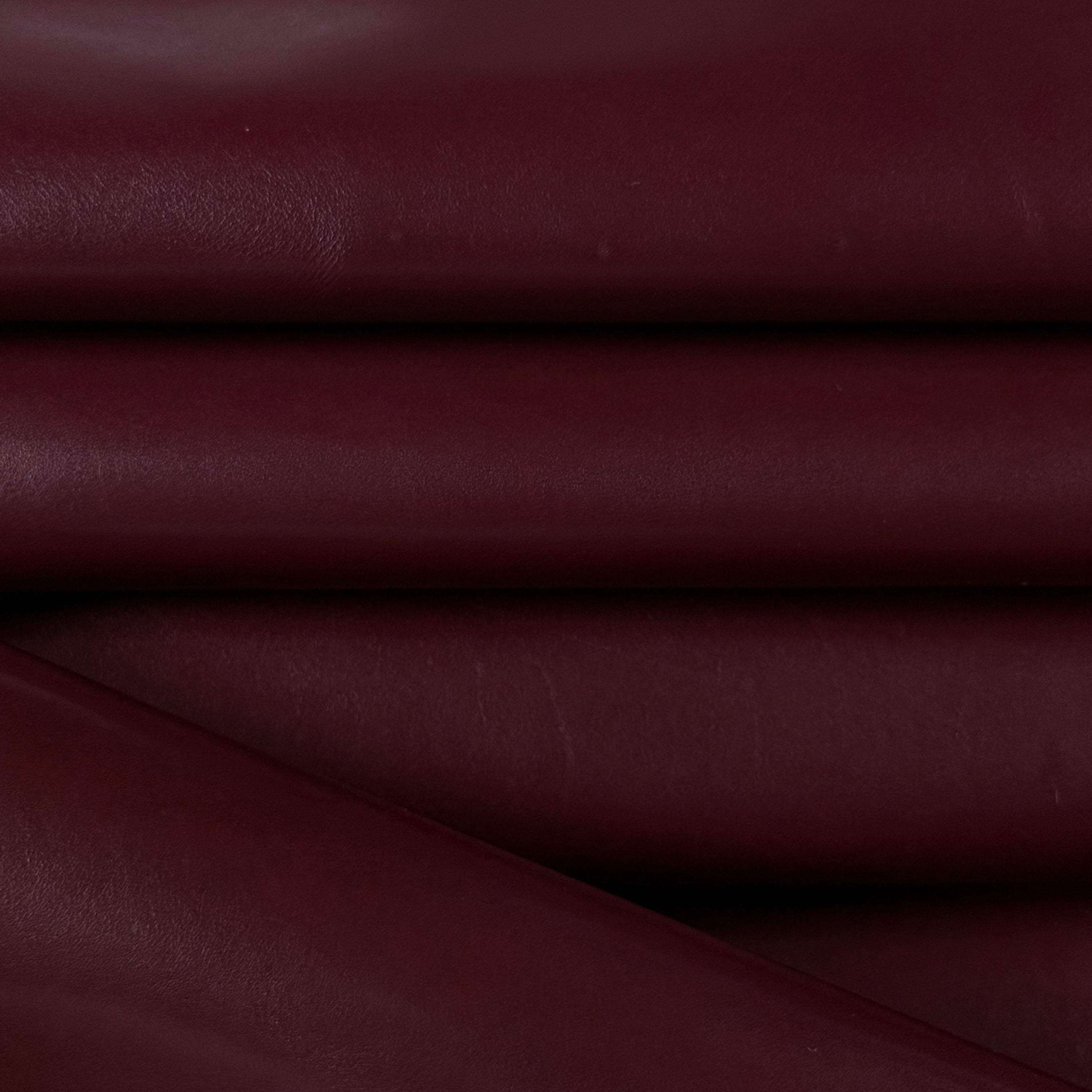Smooth, polished burgundy vegetable-tanned baby calf leather, 2 oz, showing natural texture.