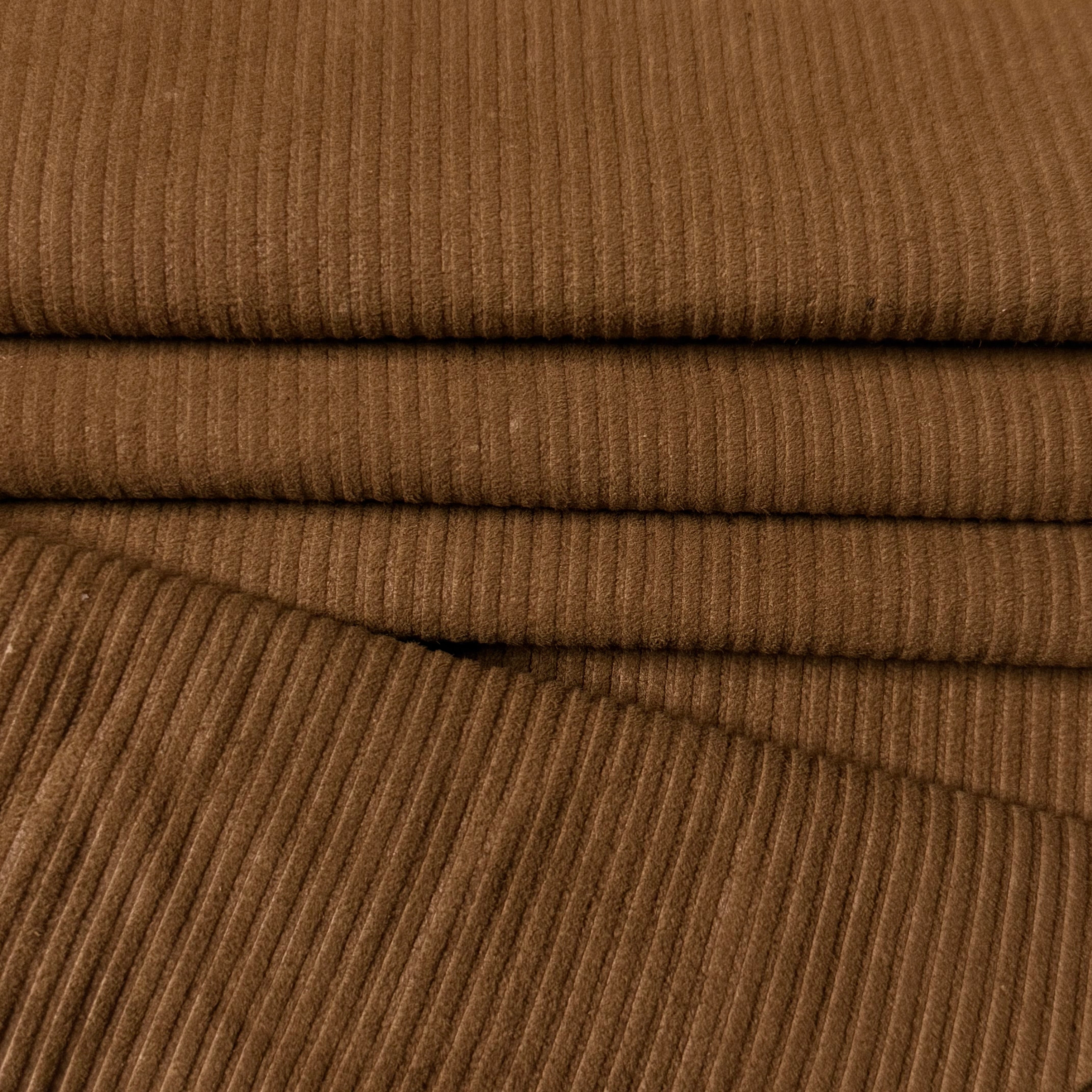 Folded brown corduroy Metis lamb suede with a ribbed texture.