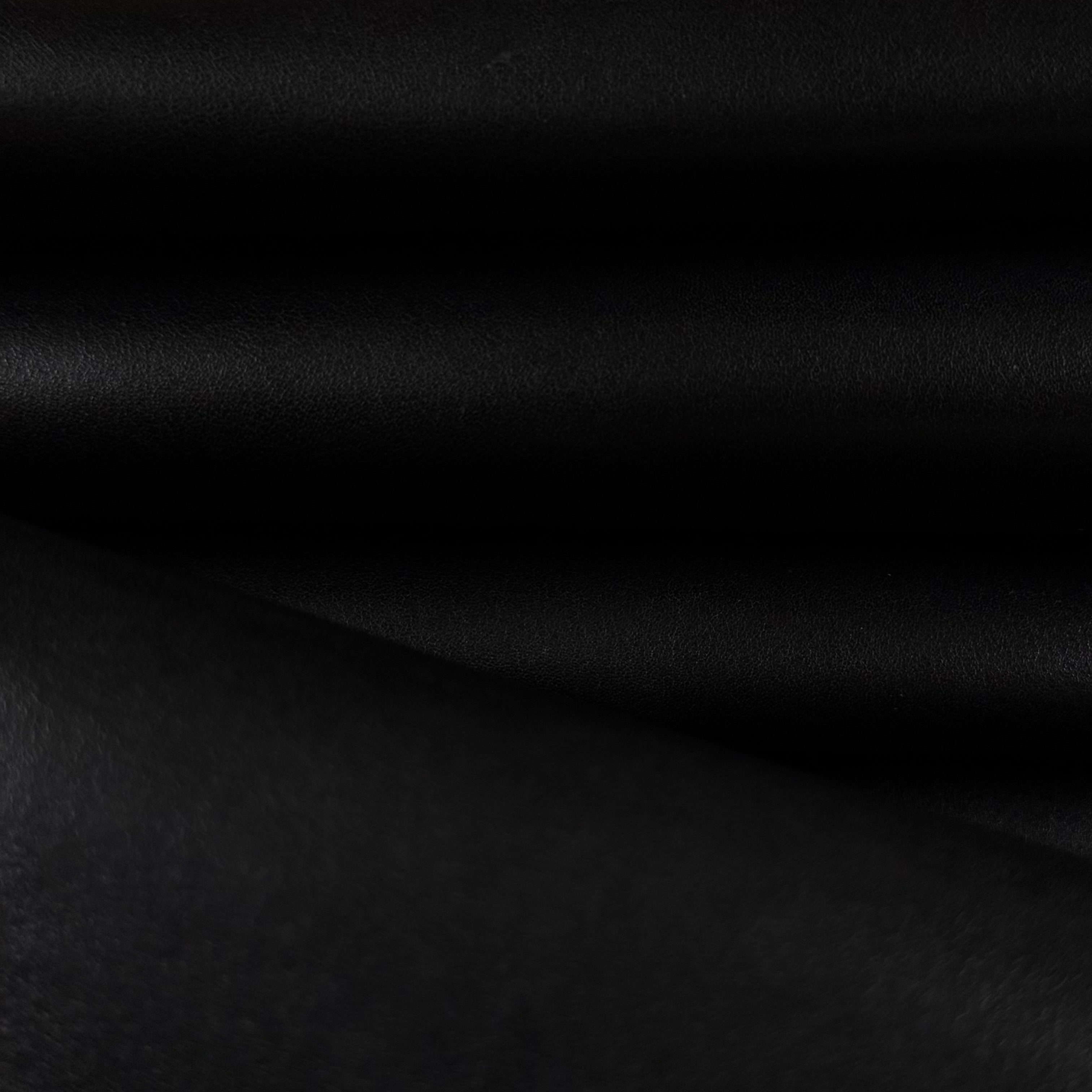 Smooth black vegetable-tanned baby calf leather with a subtle sheen and natural texture.