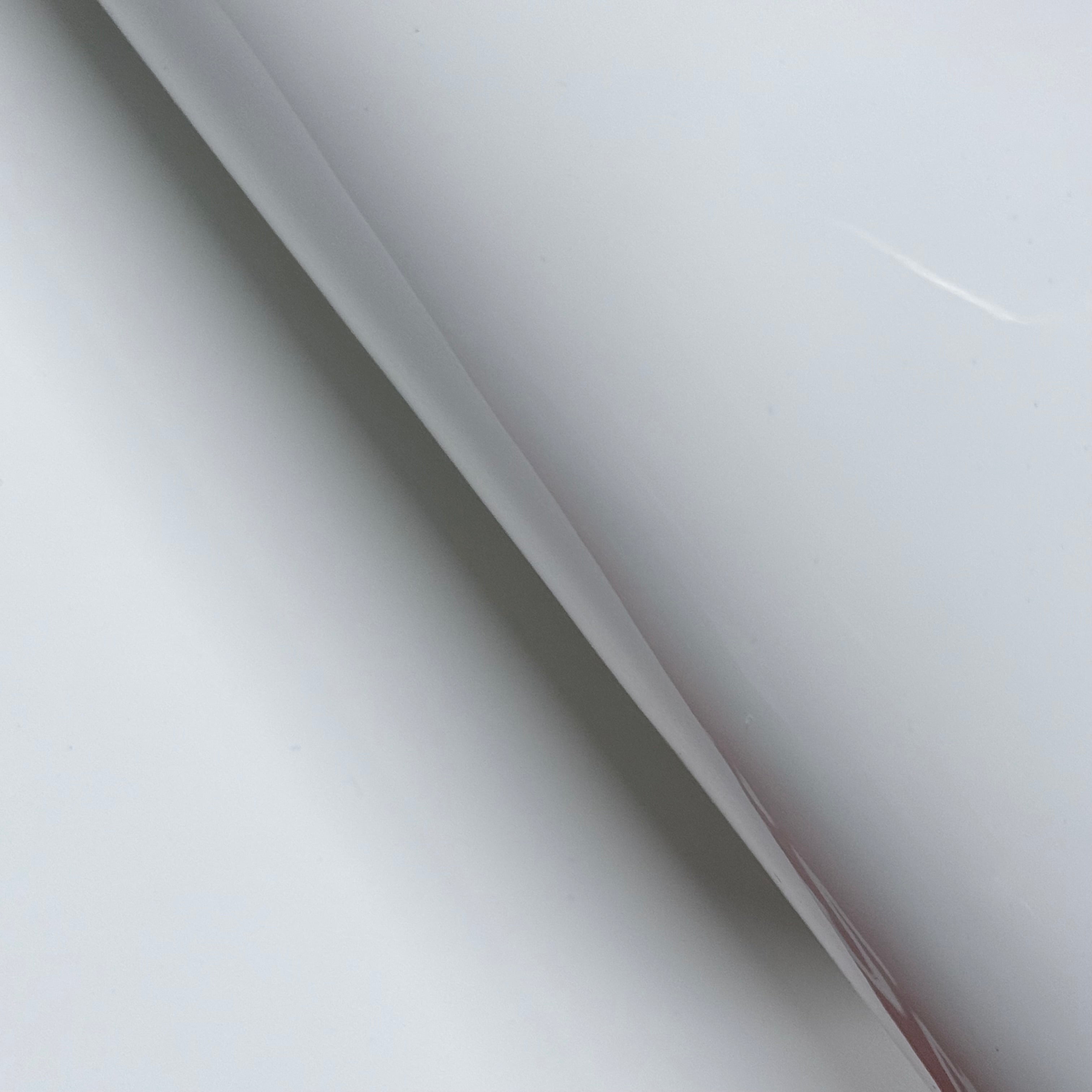 White luxury patent cow leather with a glossy lacquer finish, showing a smooth texture.
