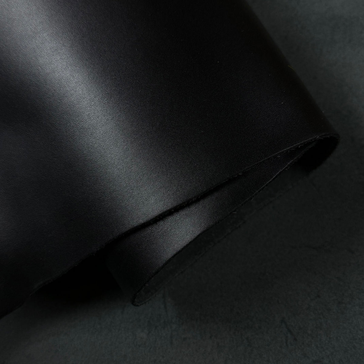 Apollo black leather material featuring a smooth, matte finish and a soft, rolled texture.