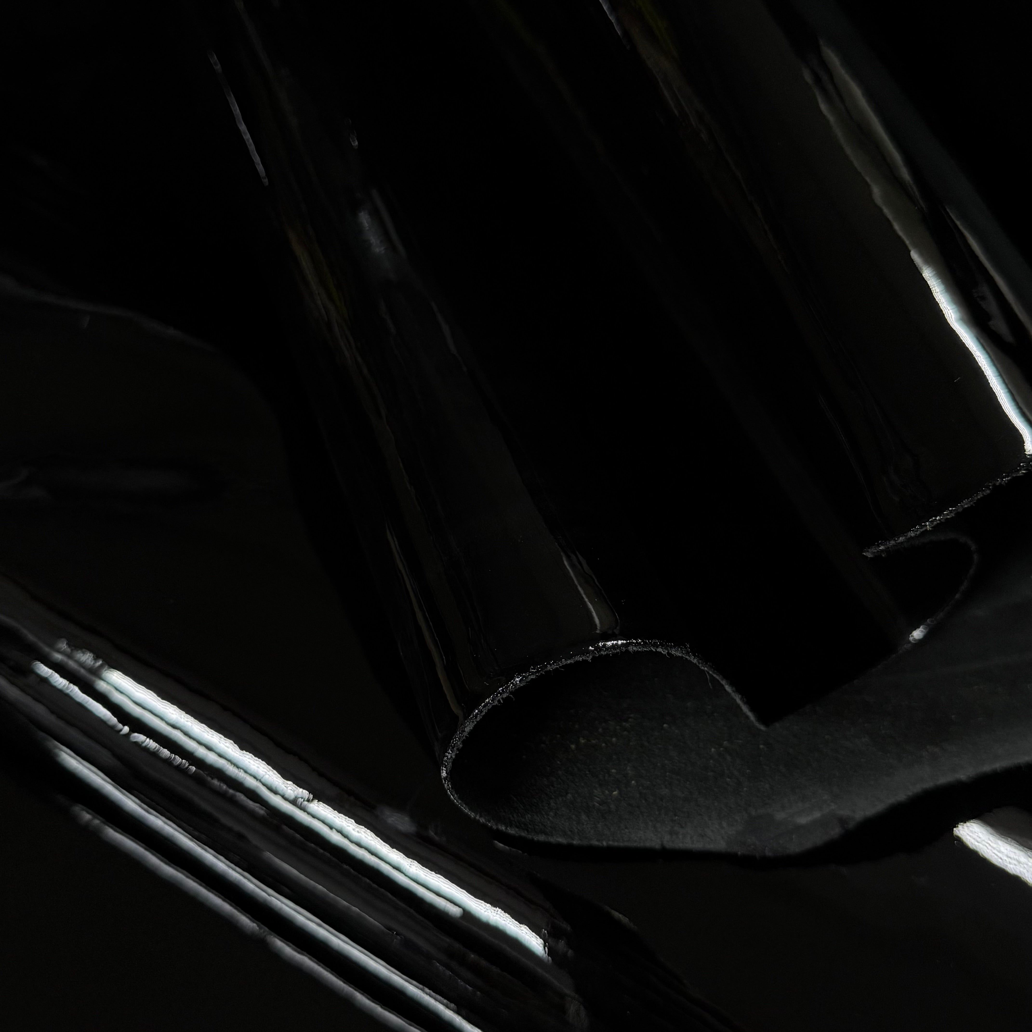 Black luxury patent cow leather with a glossy lacquer finish and smooth texture.