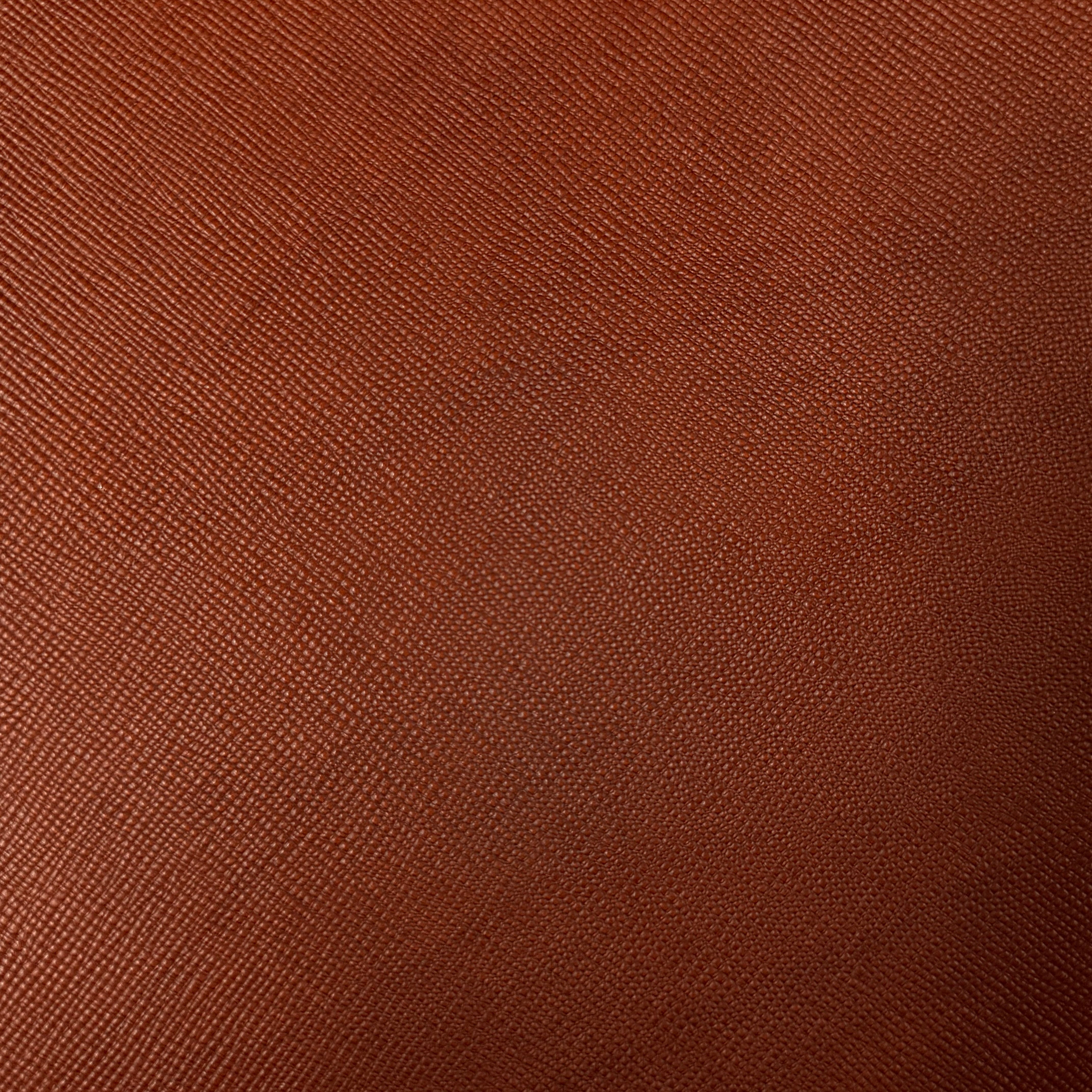 Close-up of Cognac Conceria Walpier Hatch Buttero vegetable tanned leather with a uniform embossed texture.