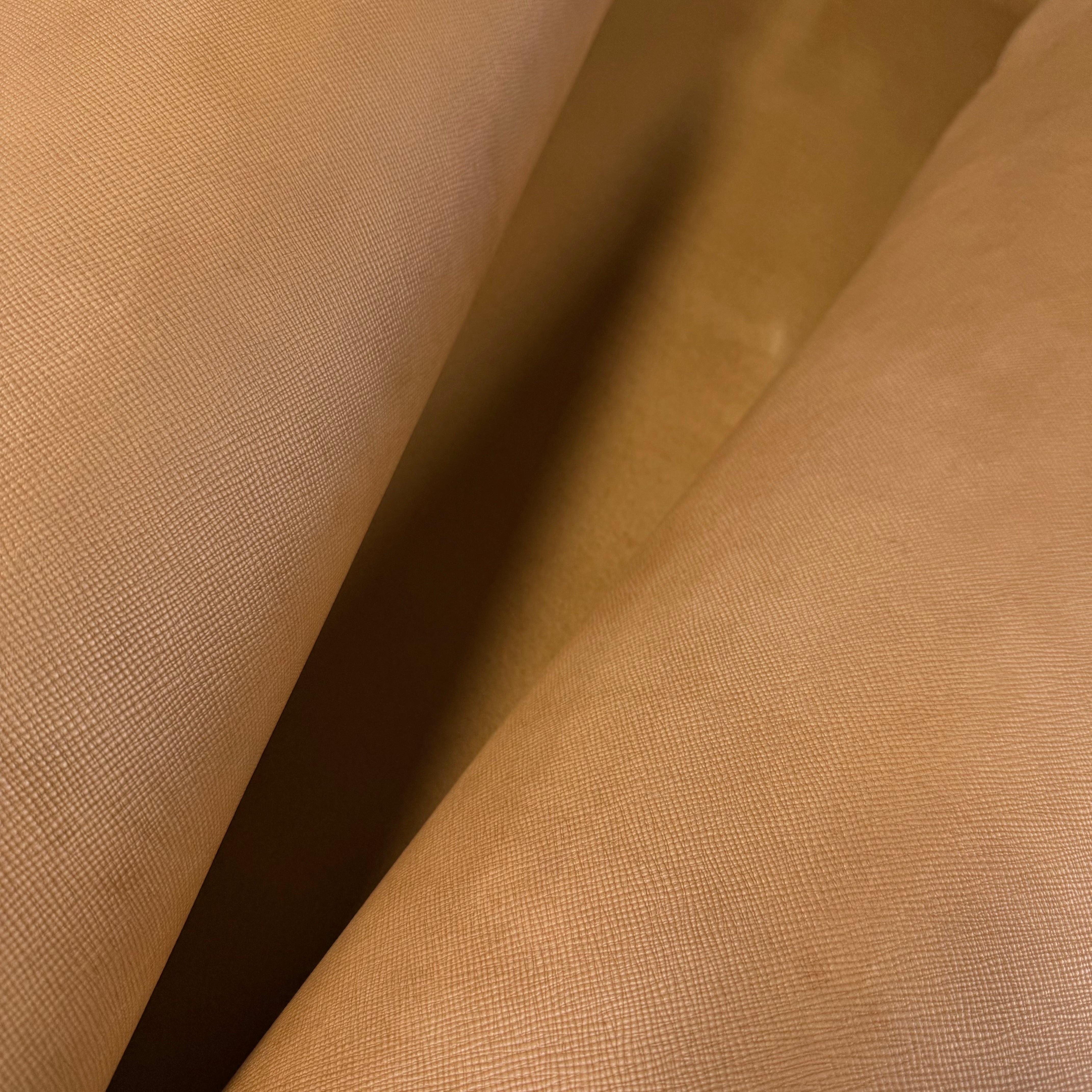 Rolled natural Conceria Walpier Hatch Buttero vegetable tanned cow leather with a uniform embossed texture.