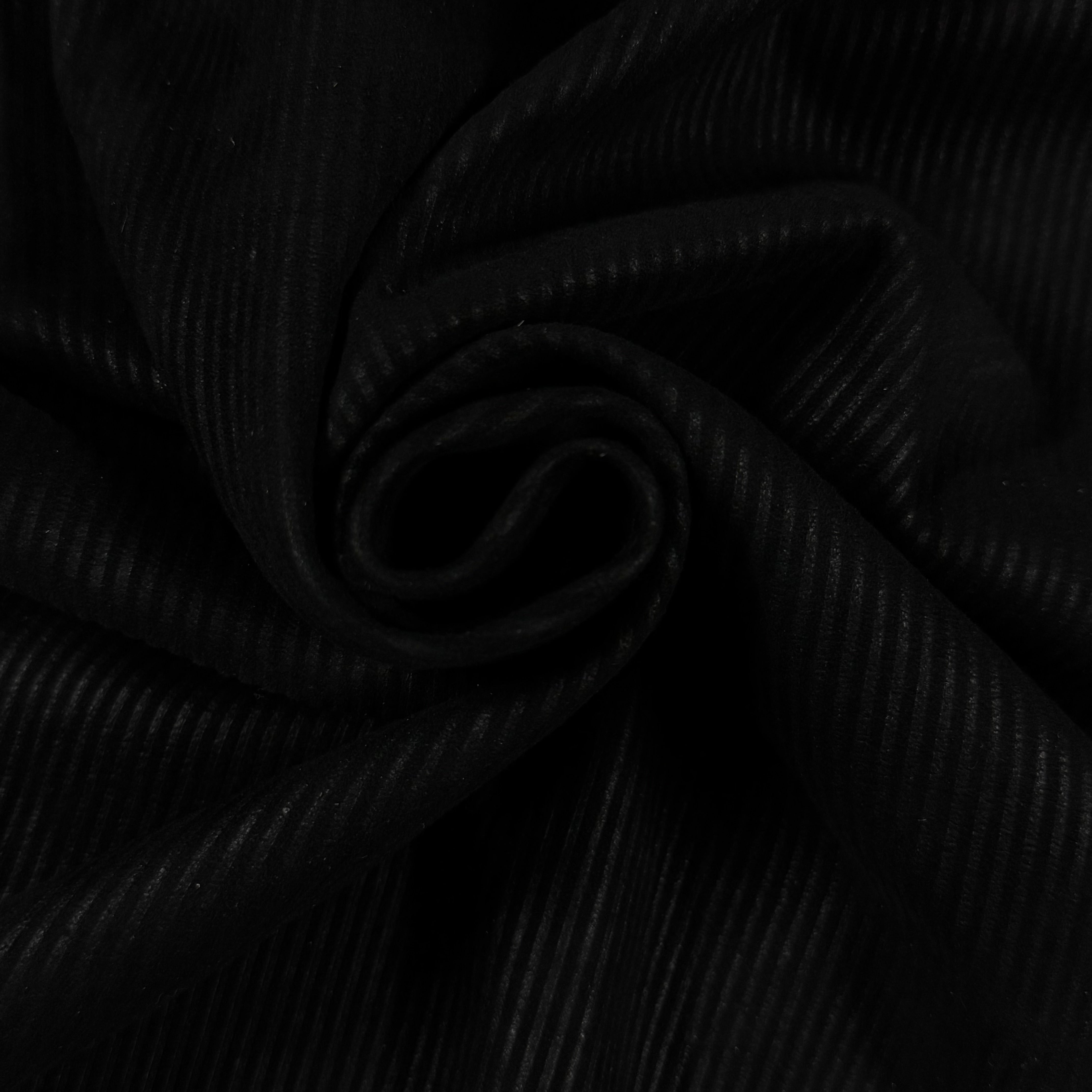 Black Corduroy Metis Lamb Suede fabric, showing its ribbed texture and soft drape.