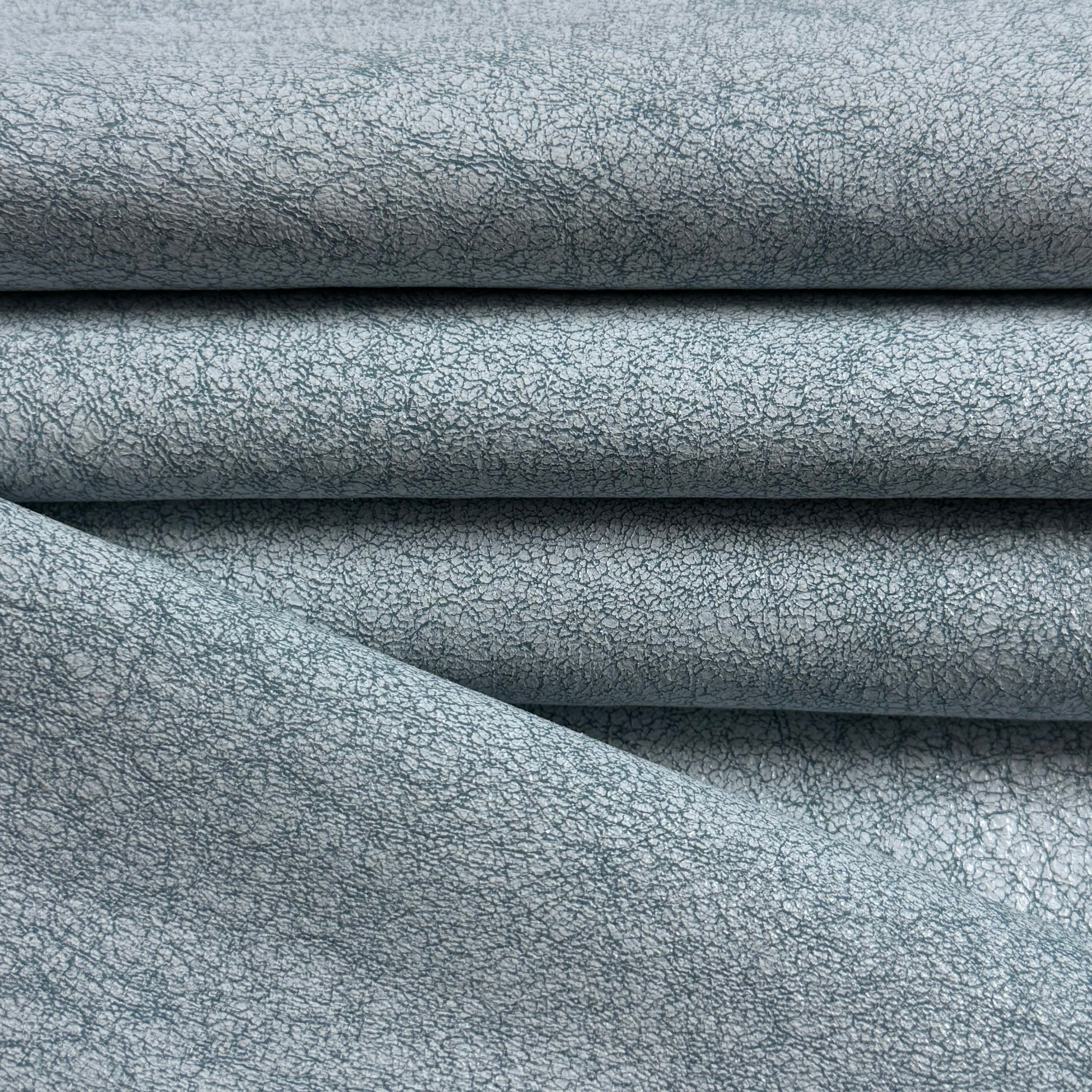 Crackle Leather in blue, featuring a textured, distressed surface with a soft, folded fabric appearance.