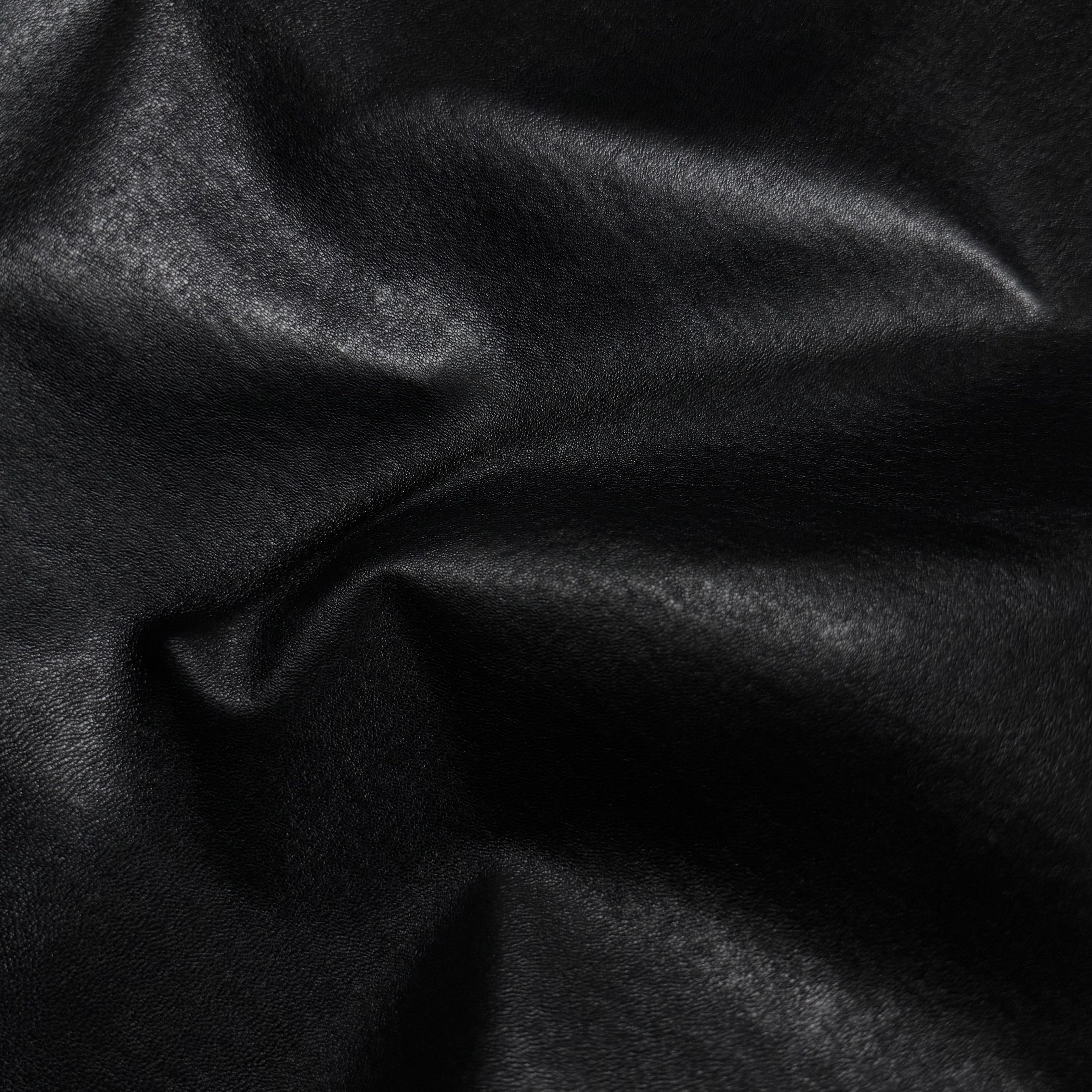 Wrinkled black Italian stretch nappa lamb leather with a smooth, semi-aniline finish and slight sheen.