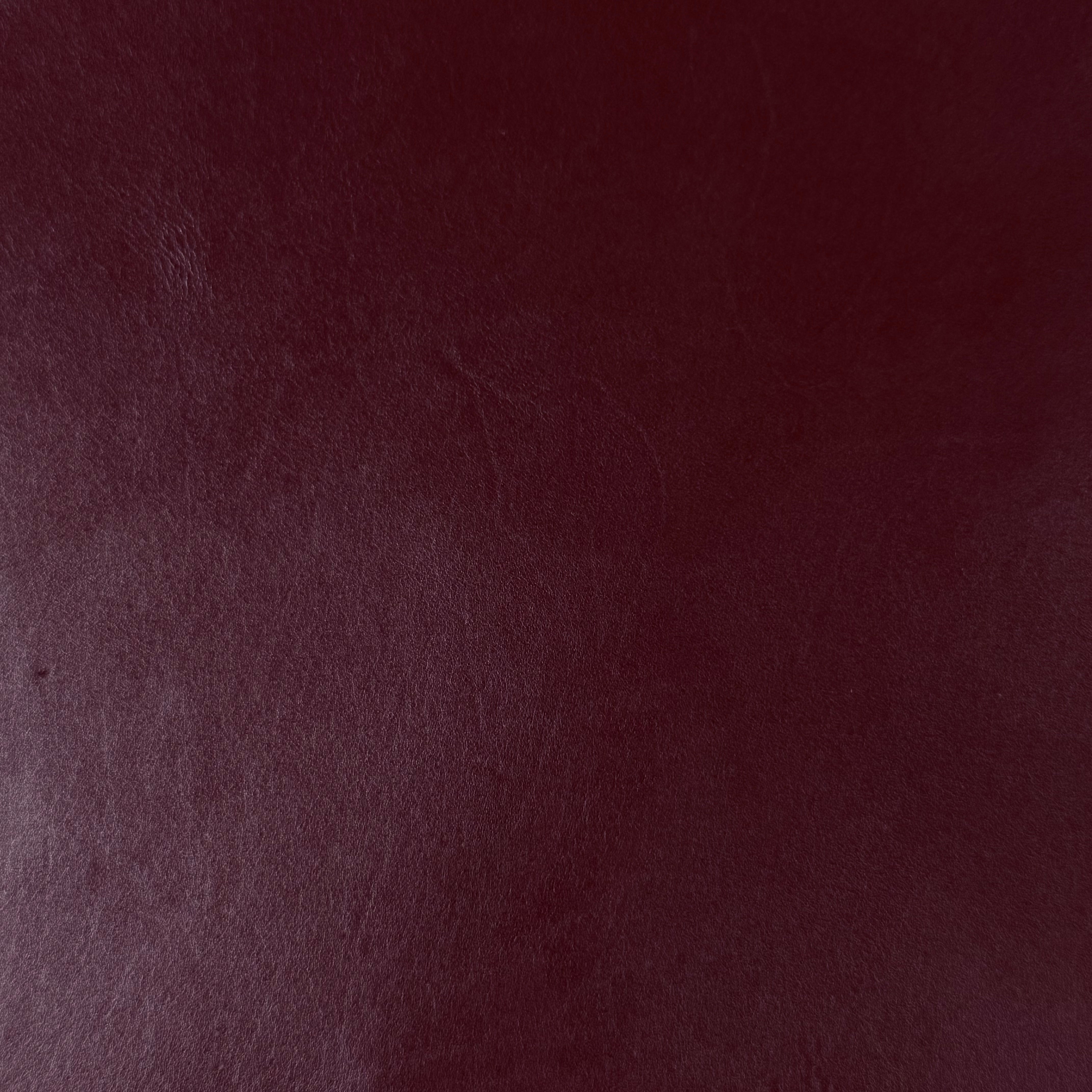 Smooth, polished burgundy vegetable-tanned baby calf leather with natural texture.