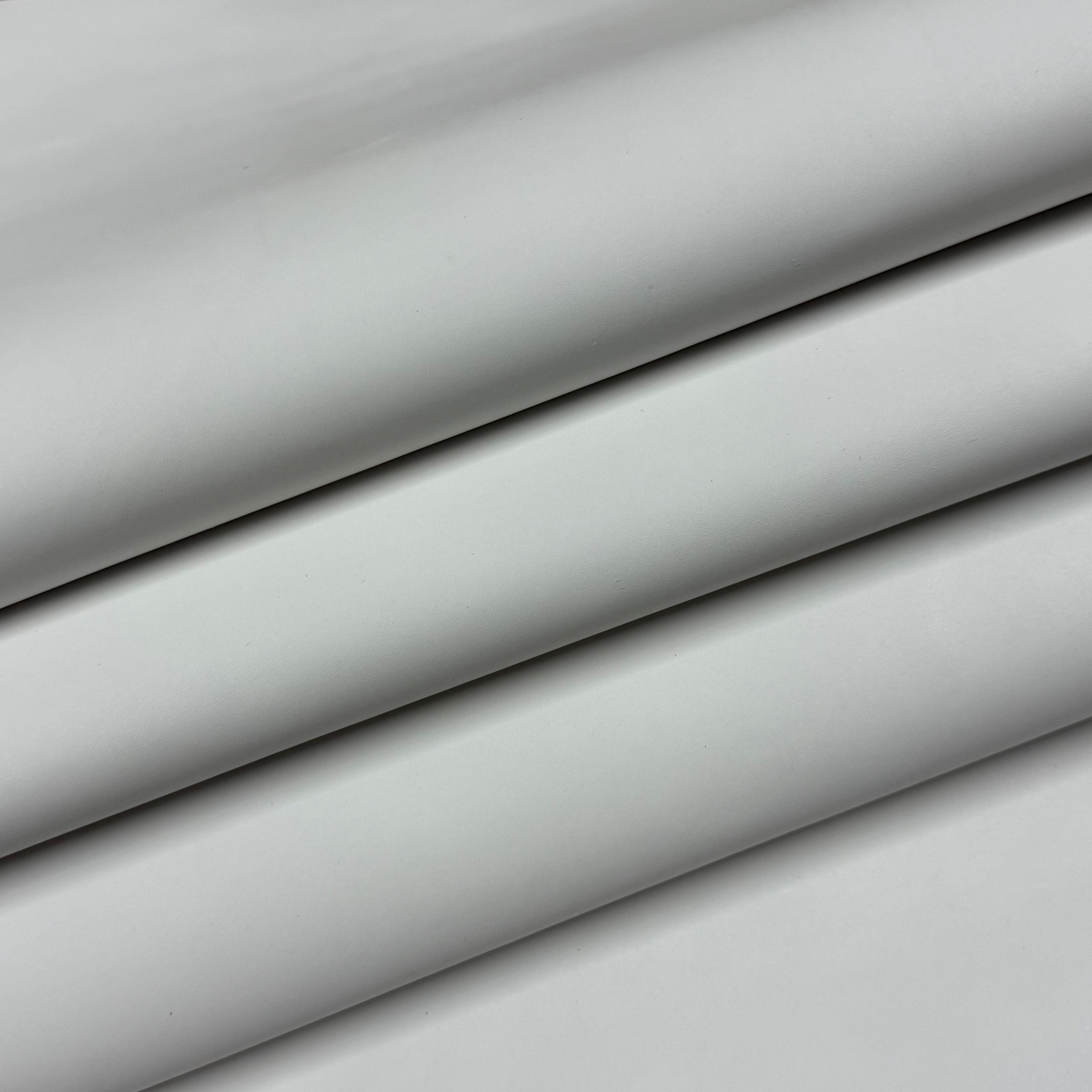 Smooth light gray vegetable-tanned baby calf leather, folded to show its polished surface and soft temper.