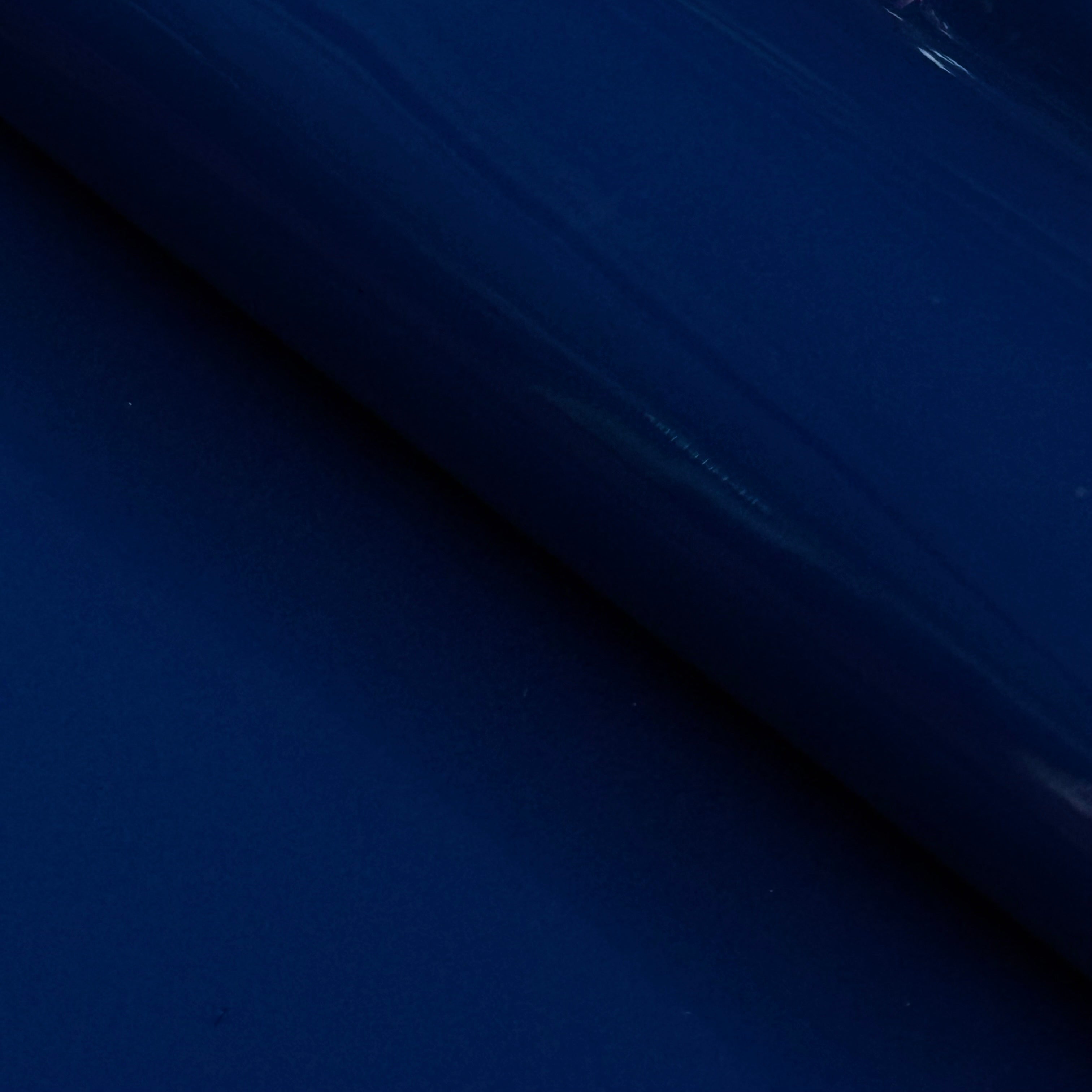 Deep blue patent cow leather with a glossy lacquer finish.