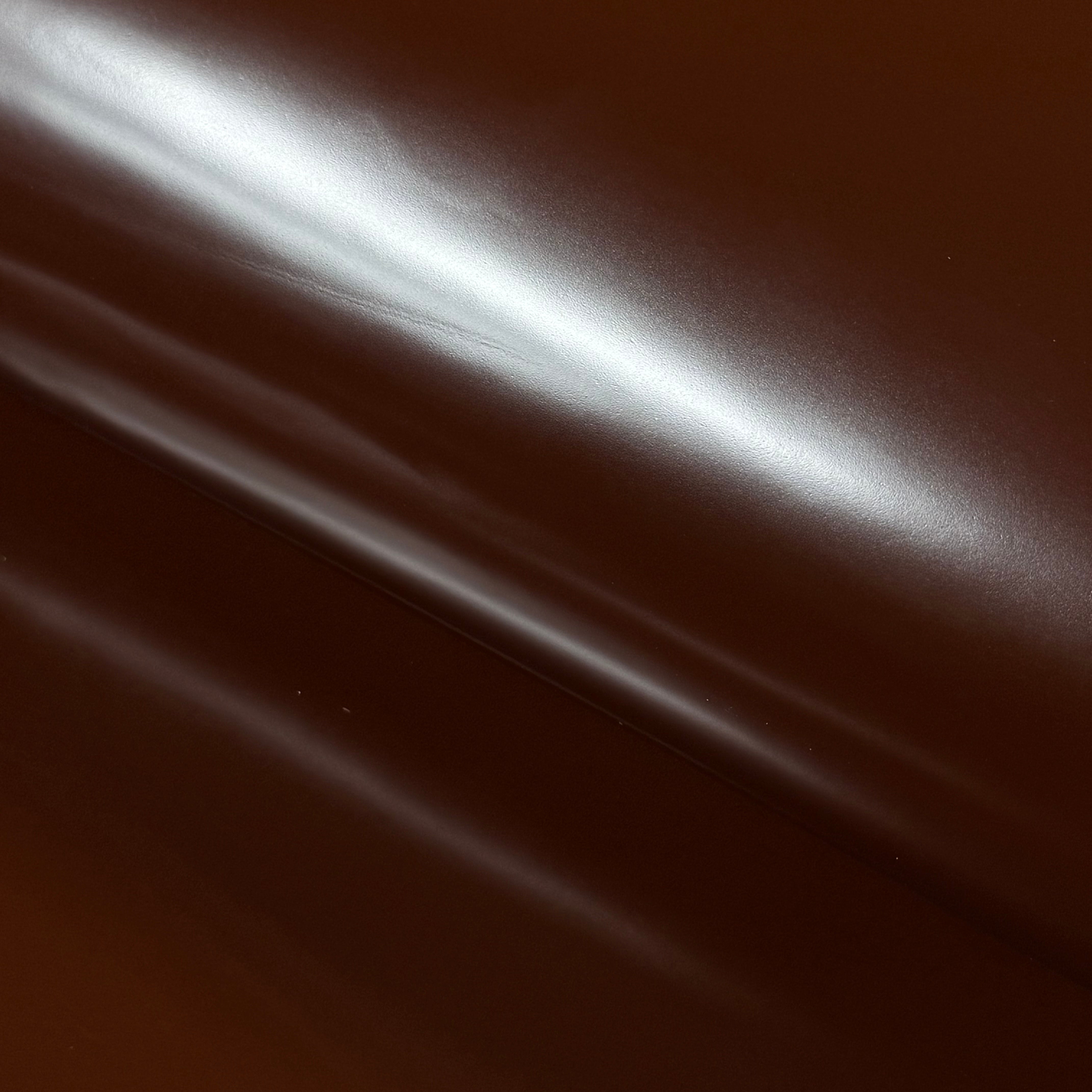 Smooth polished brown cowhide leather with a high-gloss finish and subtle folds.