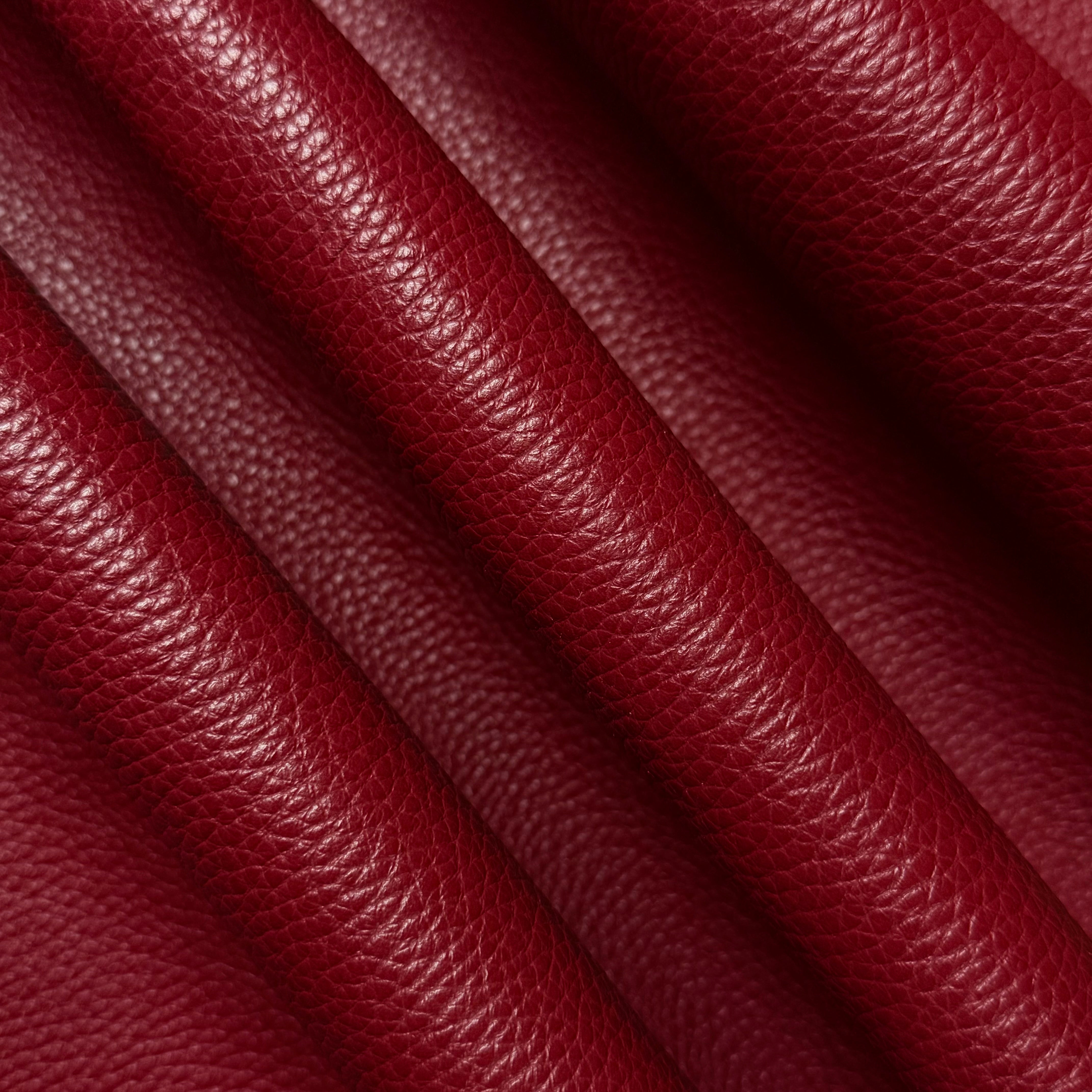 Deep red Pebble Grain Calf leather, 3-4 oz weight, featuring a rich, textured finish in soft, elegant folds.