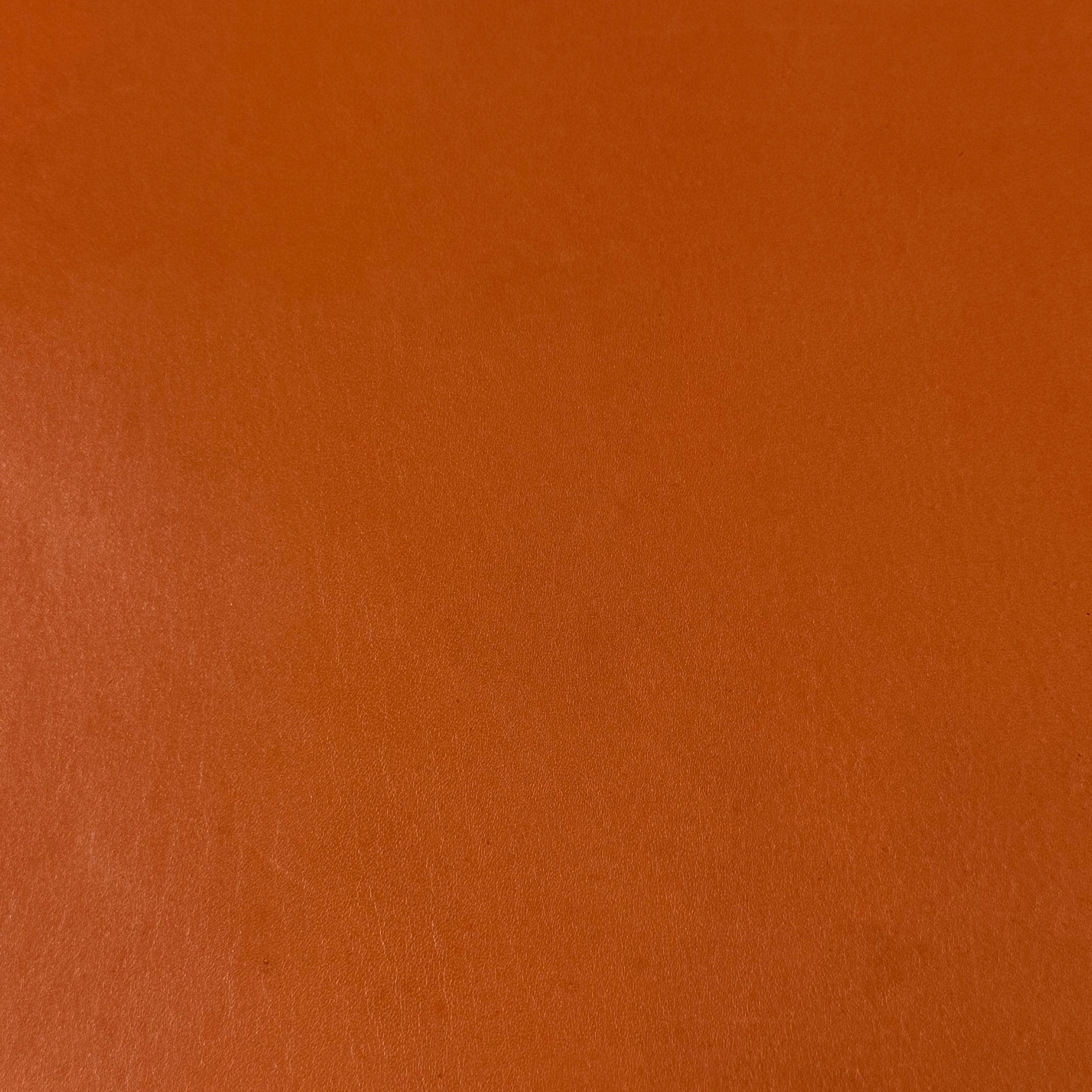Smooth, polished orange vegetable-tanned baby calf leather with natural texture, 2 oz.