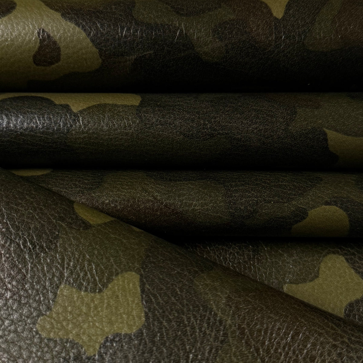 Camouflage Milled Floater Cow 3 oz leather in Woodland Camo with a textured, pebbled finish and green camo pattern.