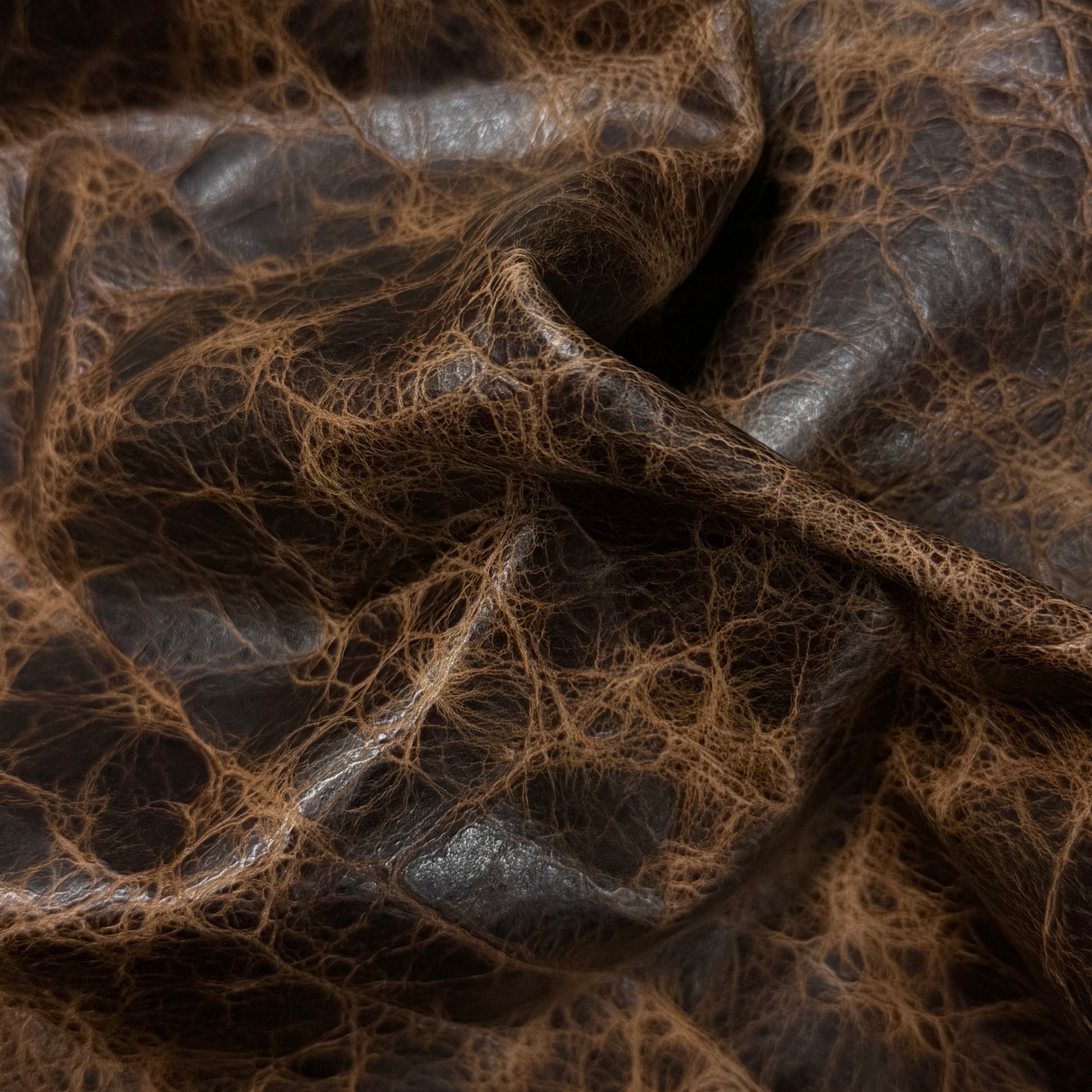Brown Carnauba Waxed Pull-Up Cowhide leather, 2-3 oz, featuring a distressed, textured finish with deep creases.