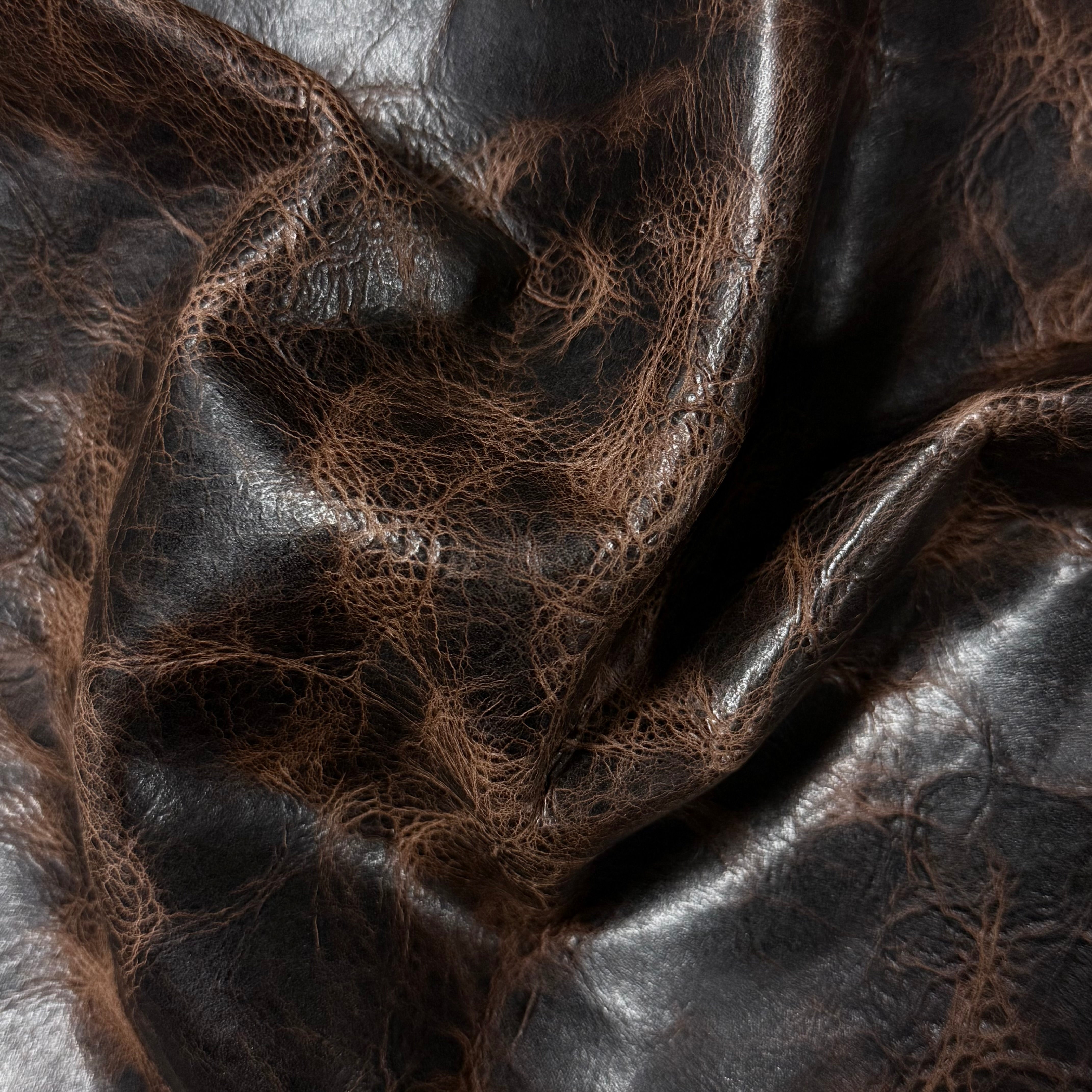 Dark brown Carnauba Waxed Pull-Up Cowhide, 2-3 oz leather with a distressed, textured finish and natural grain.