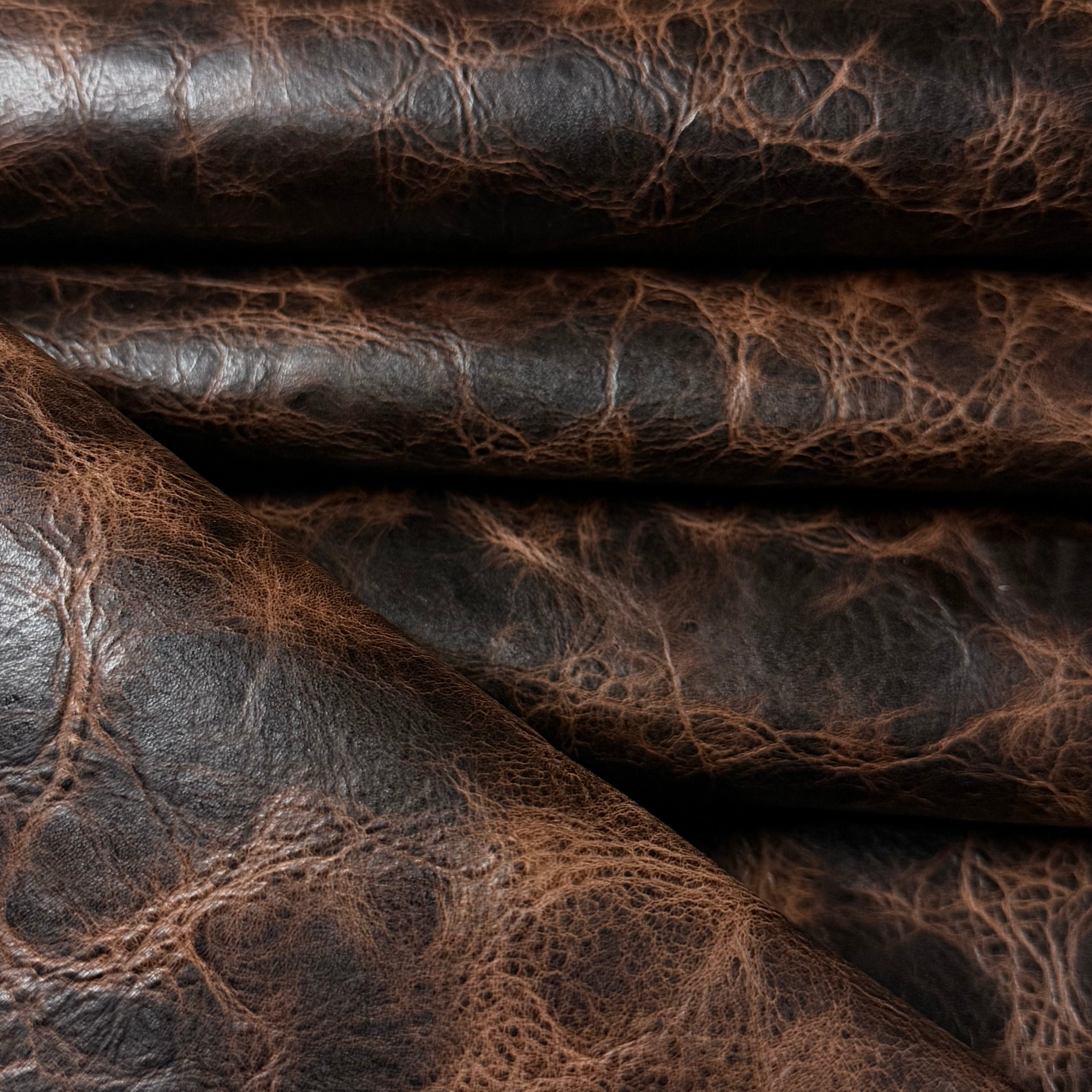 Dark brown Carnauba Waxed Pull-Up Cowhide, 2-3 oz leather with a distressed, textured finish and rich color depth.