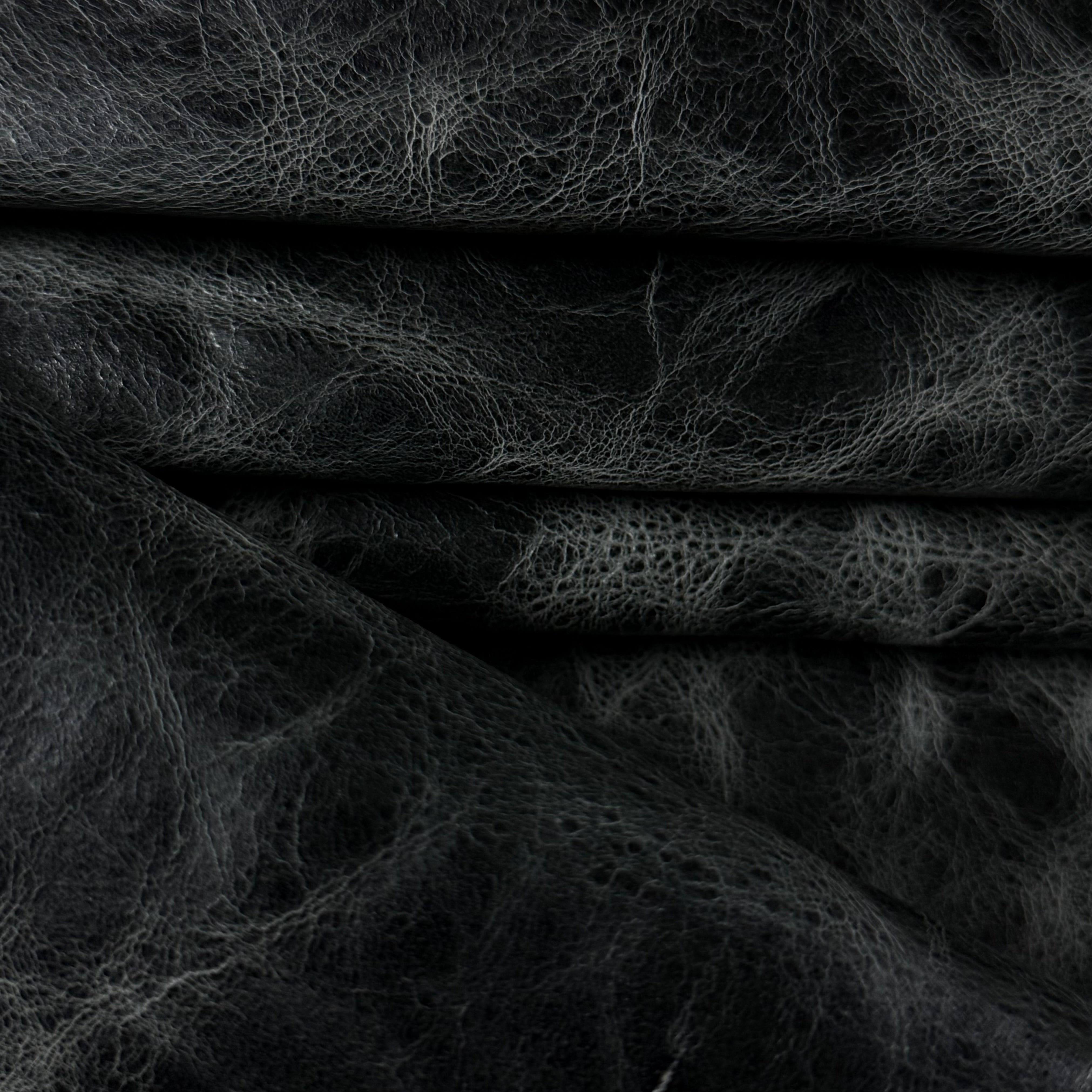 Black Carnauba Waxed Pull-Up Cowhide leather, 2-3 oz, featuring a textured, distressed finish with deep folds.