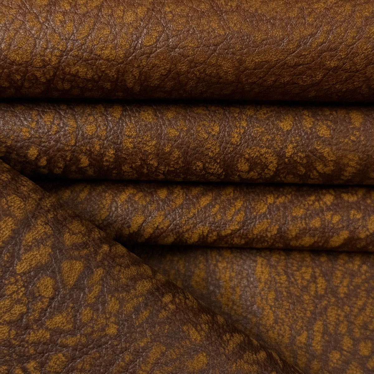 Brown Distressed Buffed Elephant Embossed Cowhide leather, 3 oz, featuring a textured, multi-tonal grain pattern.
