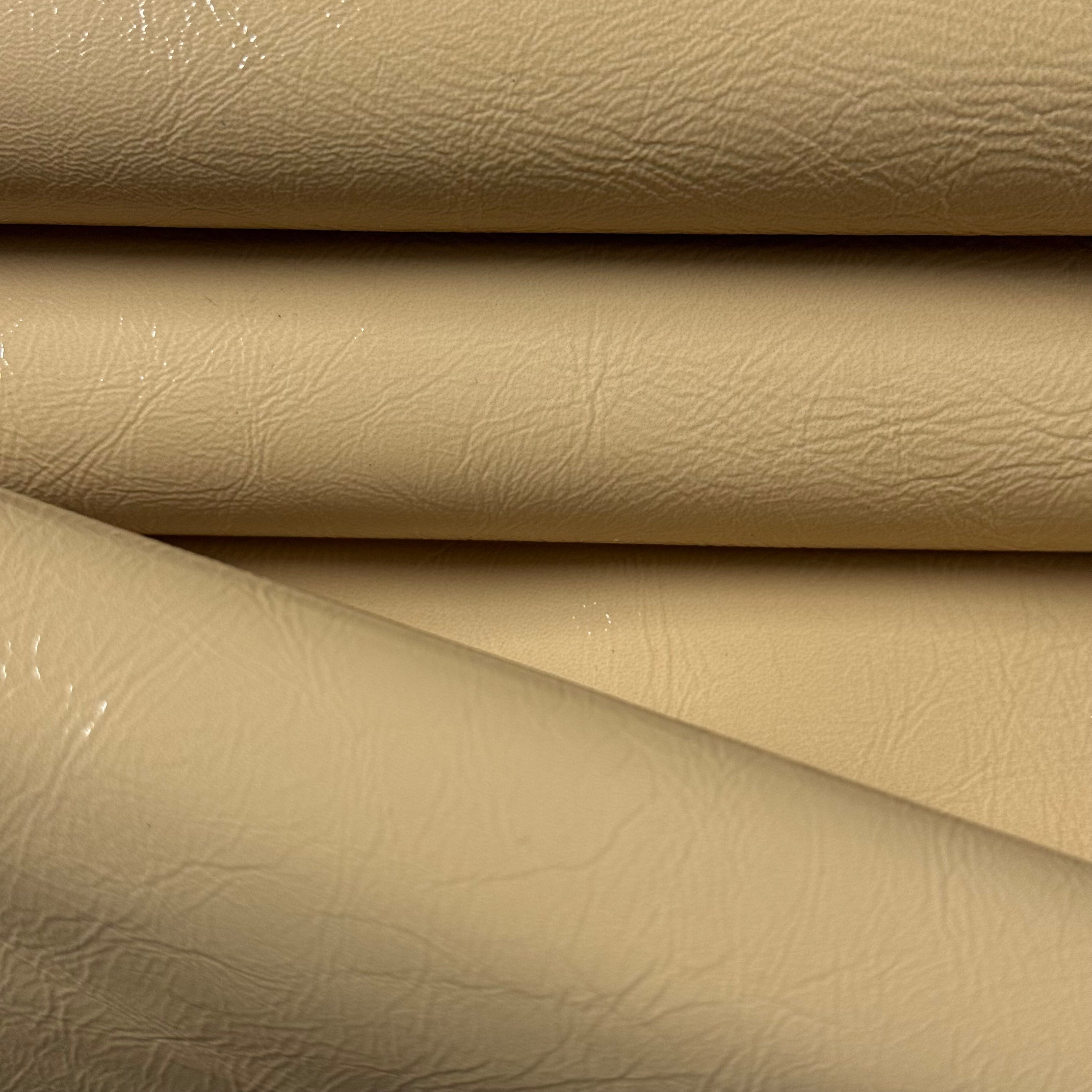 Beige distressed crinkle patent lamb leather with a glossy finish and textured surface, folded.