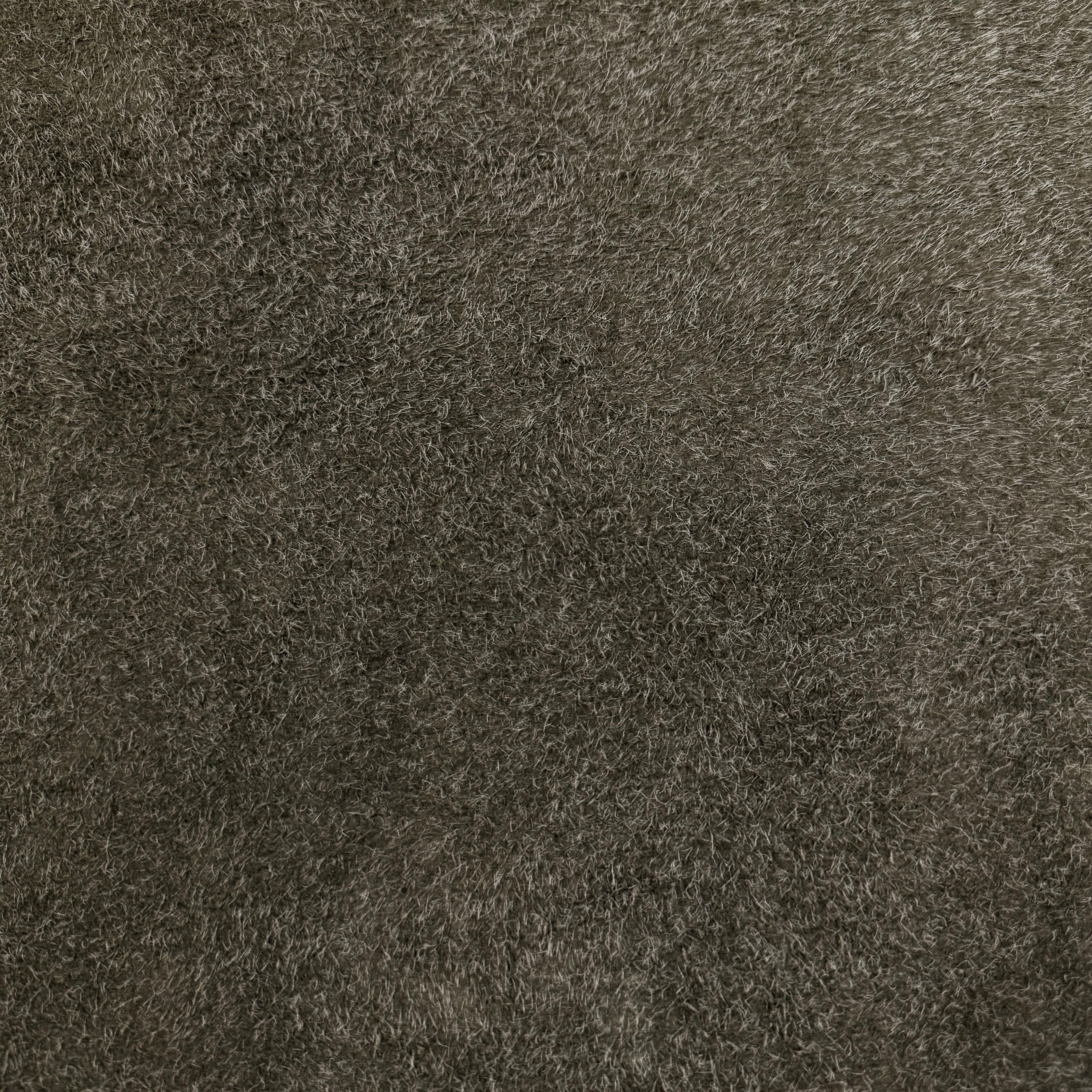 Close-up of a dark brown hairy calf suede bend with long, shaggy fibers and a rough-out texture.
