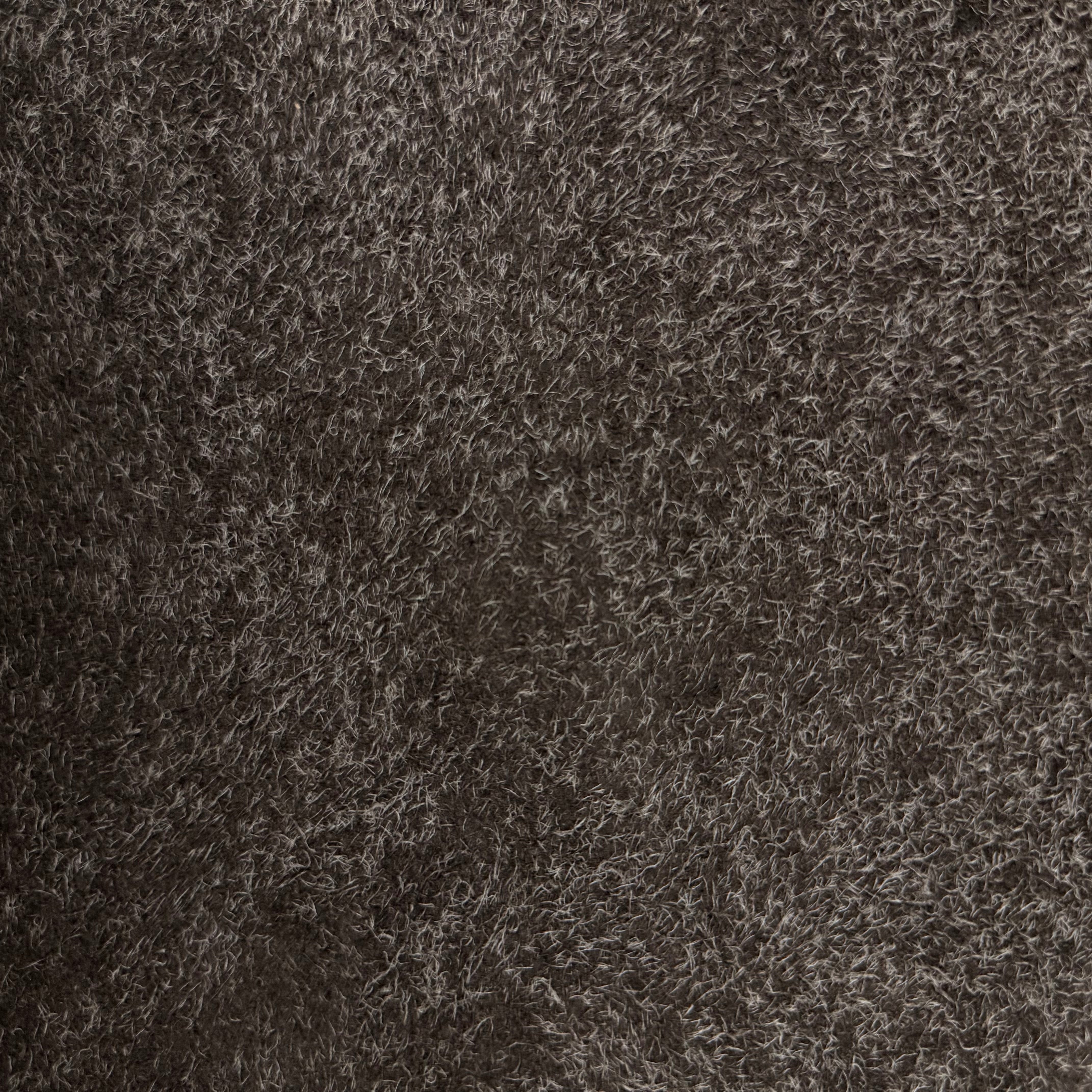 Dark brown hairy calf suede leather with long, shaggy fibers and a rough-out texture.
