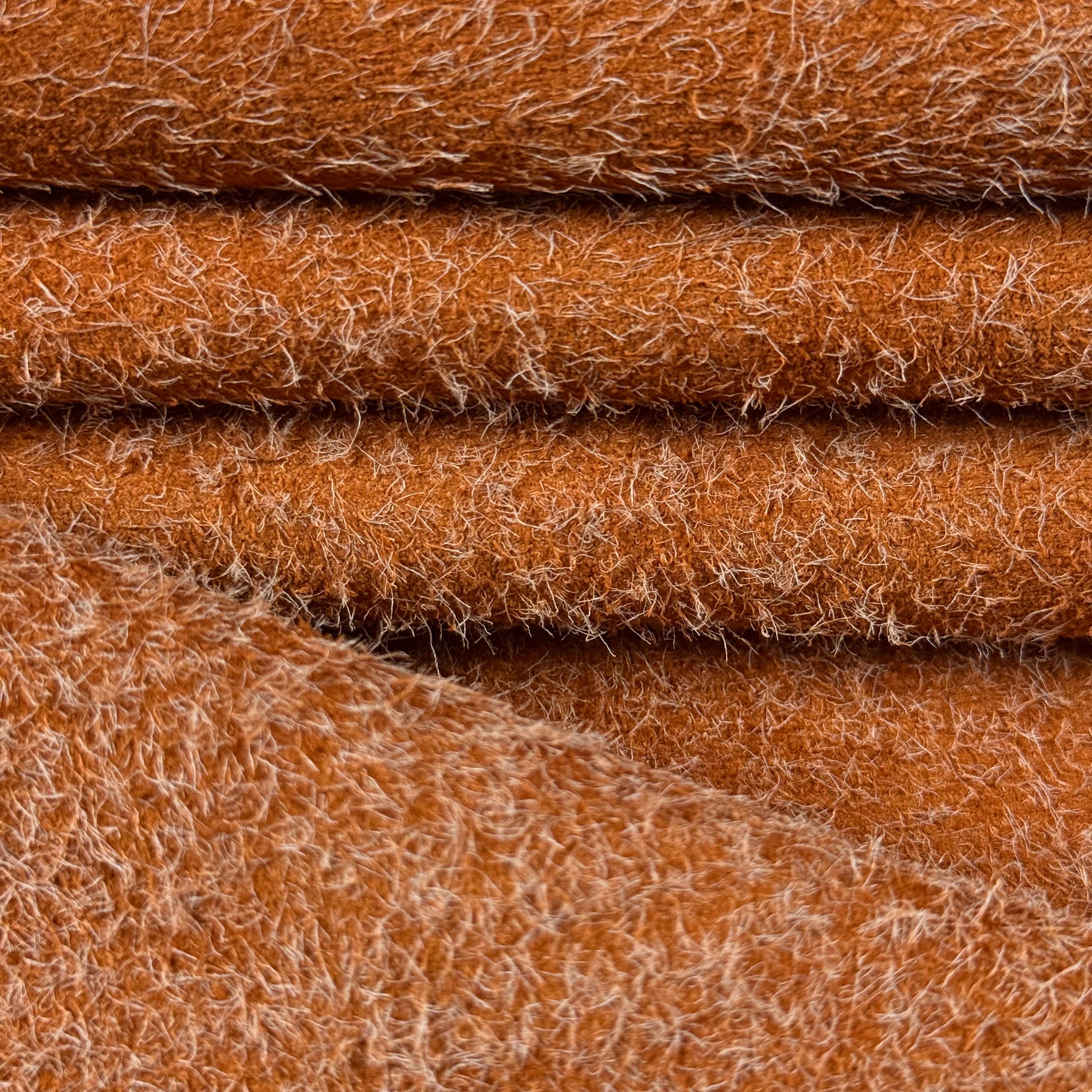 Close-up of folded Hairy Calf Suede Bends in a rich brown with contrasting long, shaggy fibers.