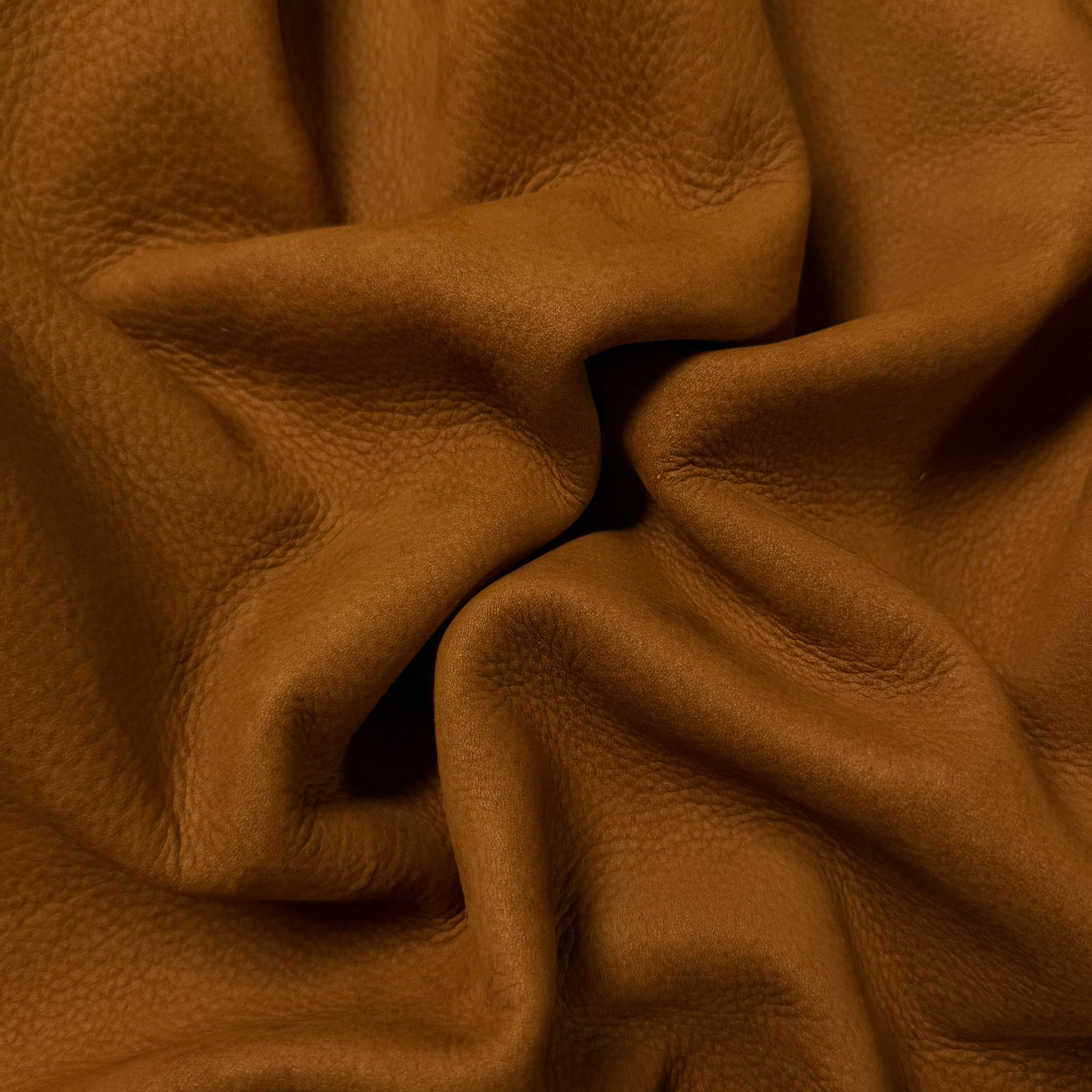Premium Top Grain Nubuck Cowhide in tan, 3-4 oz leather with a soft, textured, and folded matte finish.