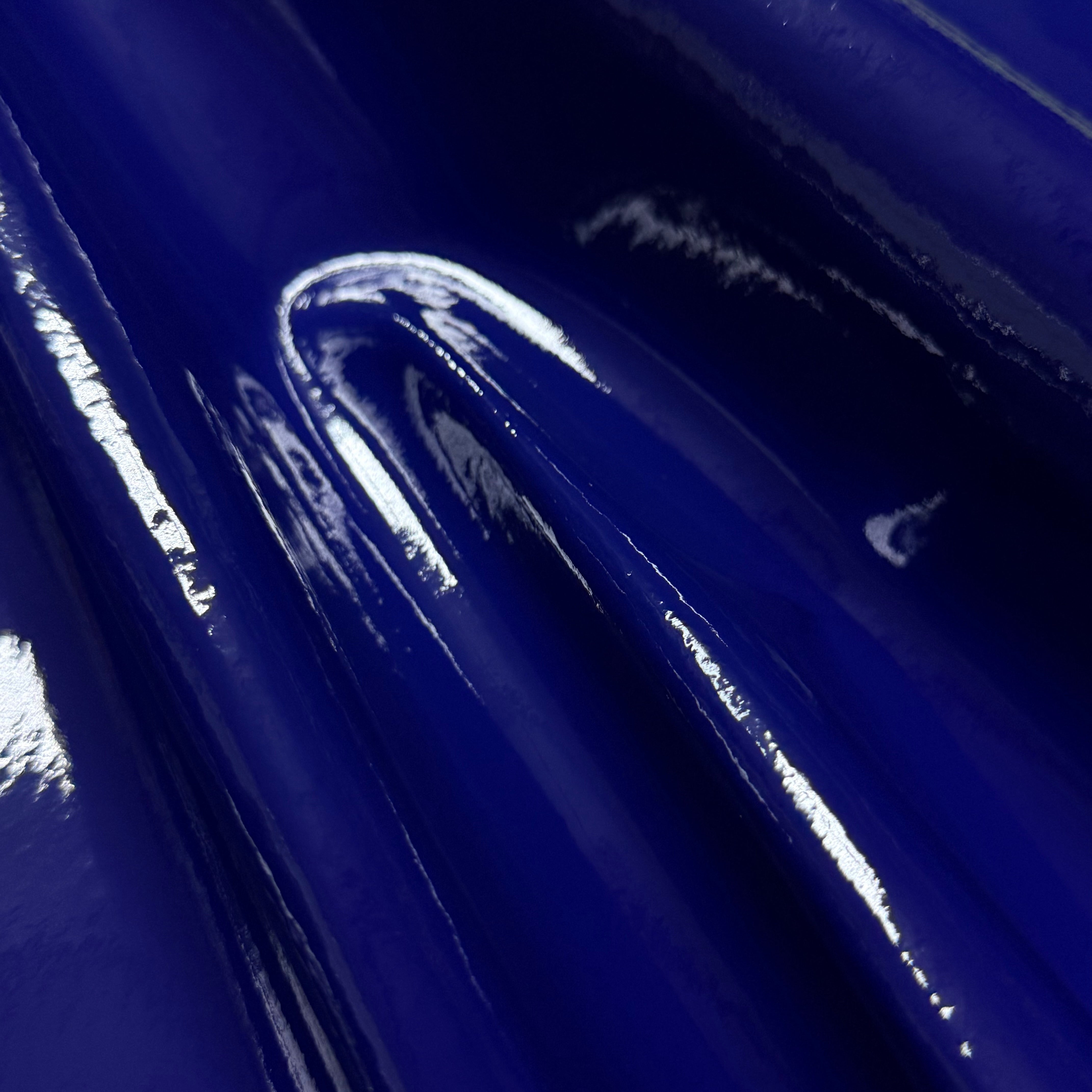Patent Pig 1-2 oz leather in a glossy, deep blue finish with a smooth, reflective surface texture.
