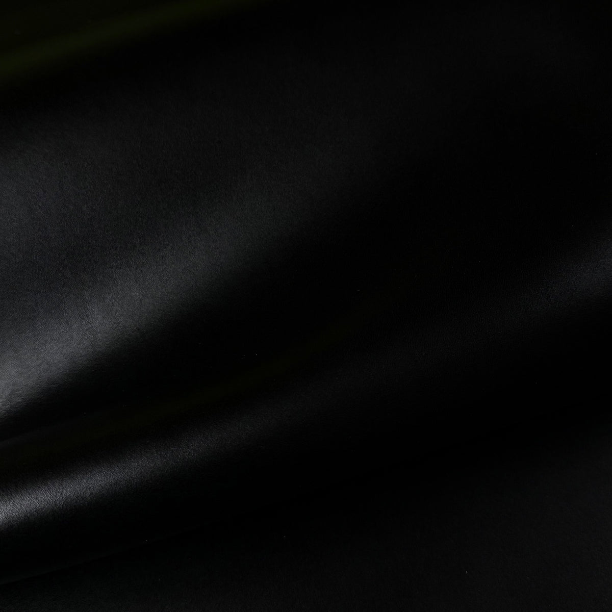 Apollo fabric in black, featuring a smooth, matte texture with soft, elegant folds and a premium finish.