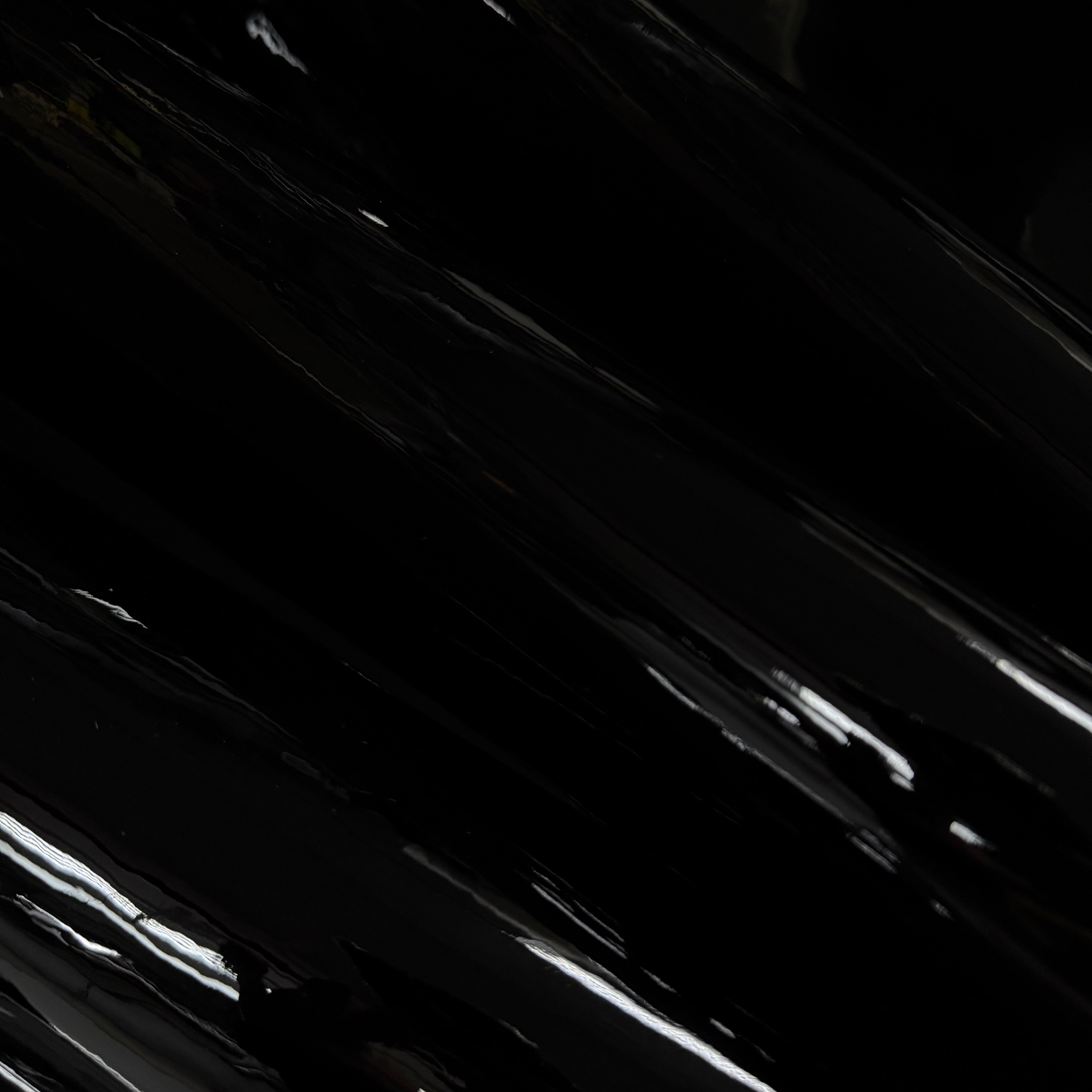 Black luxury patent cow leather with a glossy lacquer finish and reflective surface.