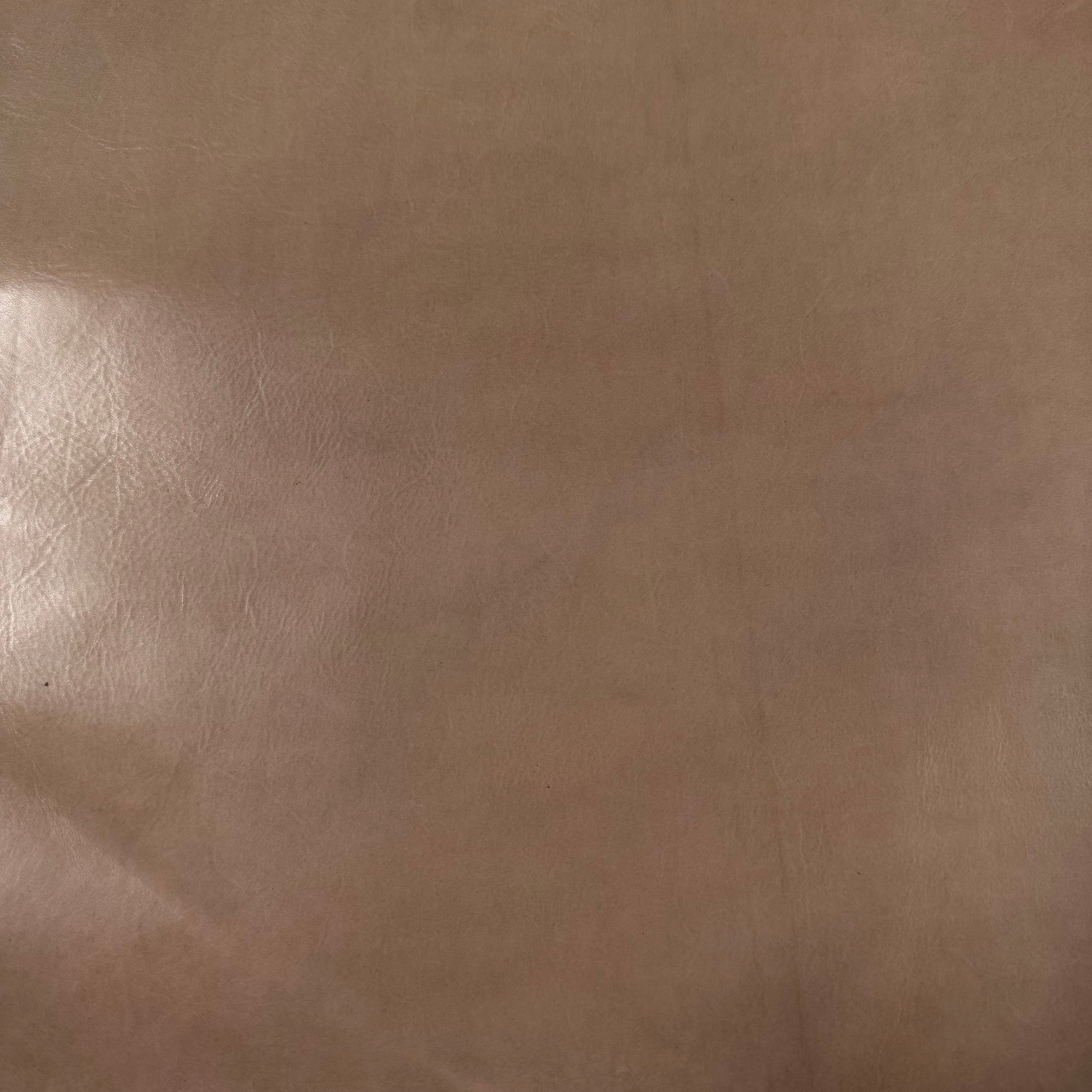 Smooth, polished tan vegetable-tanned baby calf leather with natural variations.