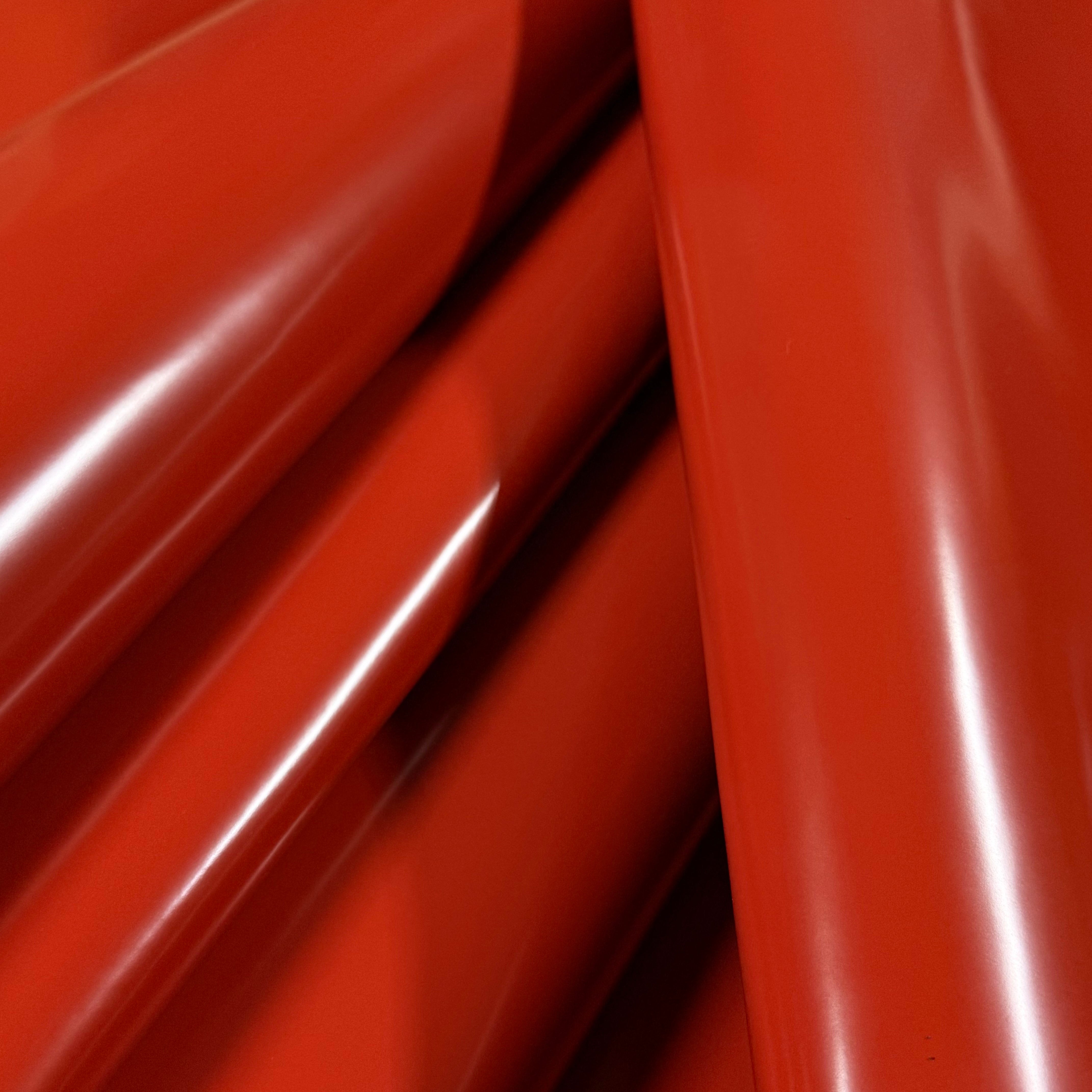 Smooth, polished red cowhide leather with a high-gloss finish, showing subtle folds.