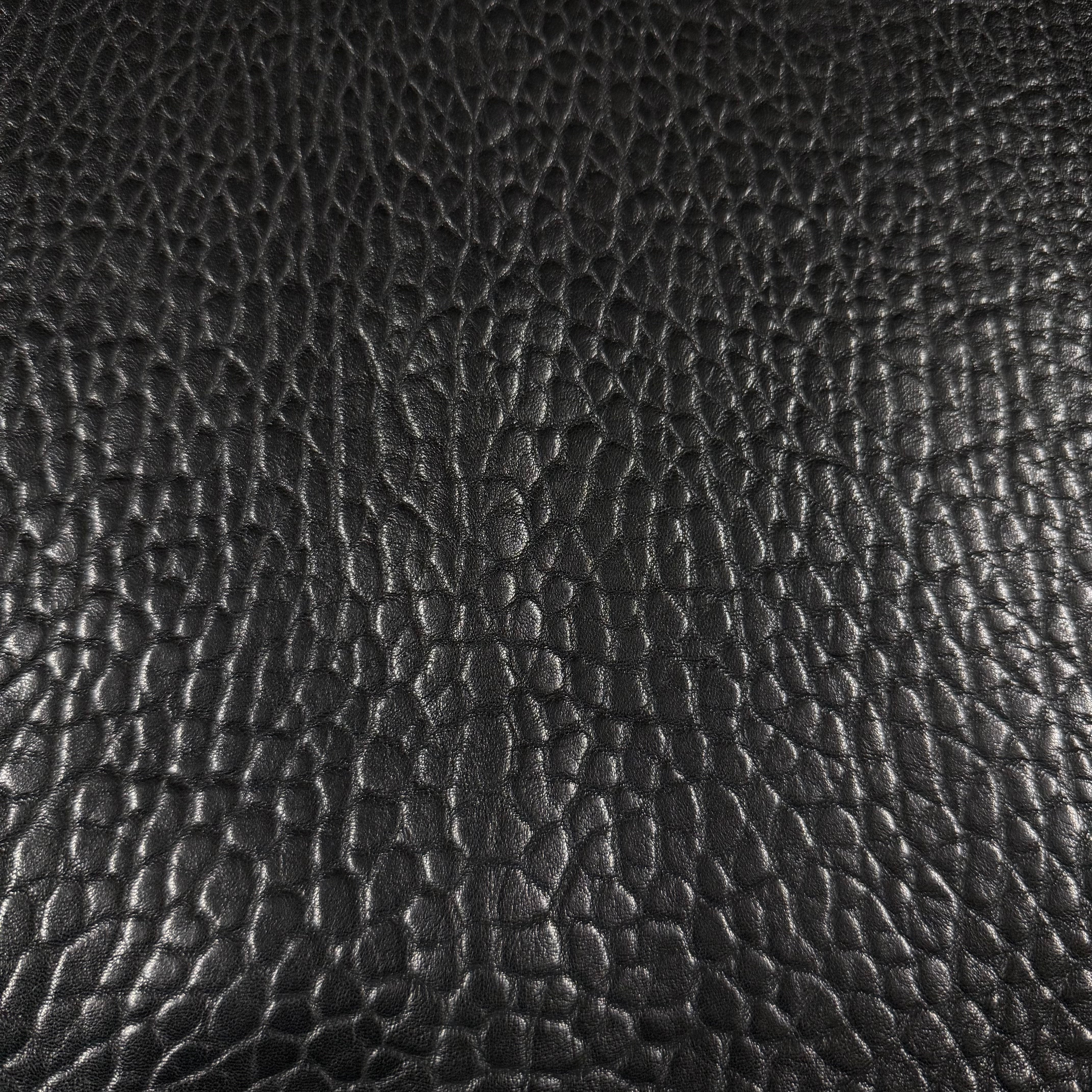 Black Shrunken Bubble Grain Veg Tan Lamb leather with a natural, krispy textured surface.