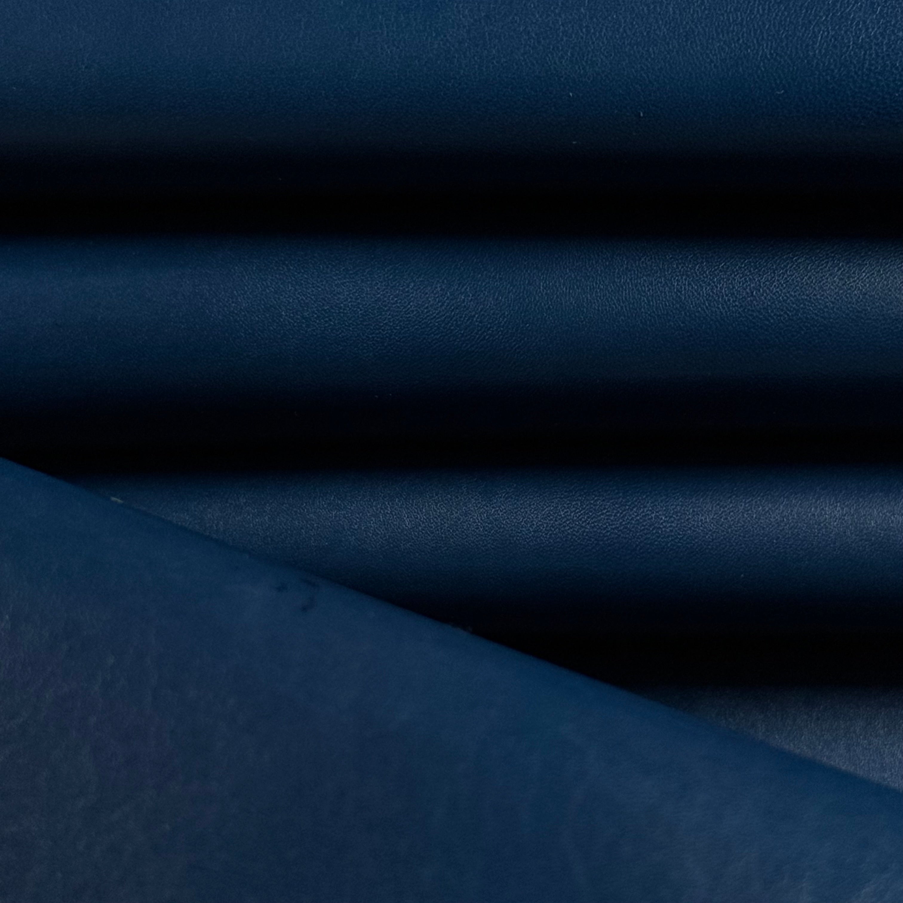 Smooth navy blue vegetable-tanned baby calf leather, folded with a polished aniline finish.