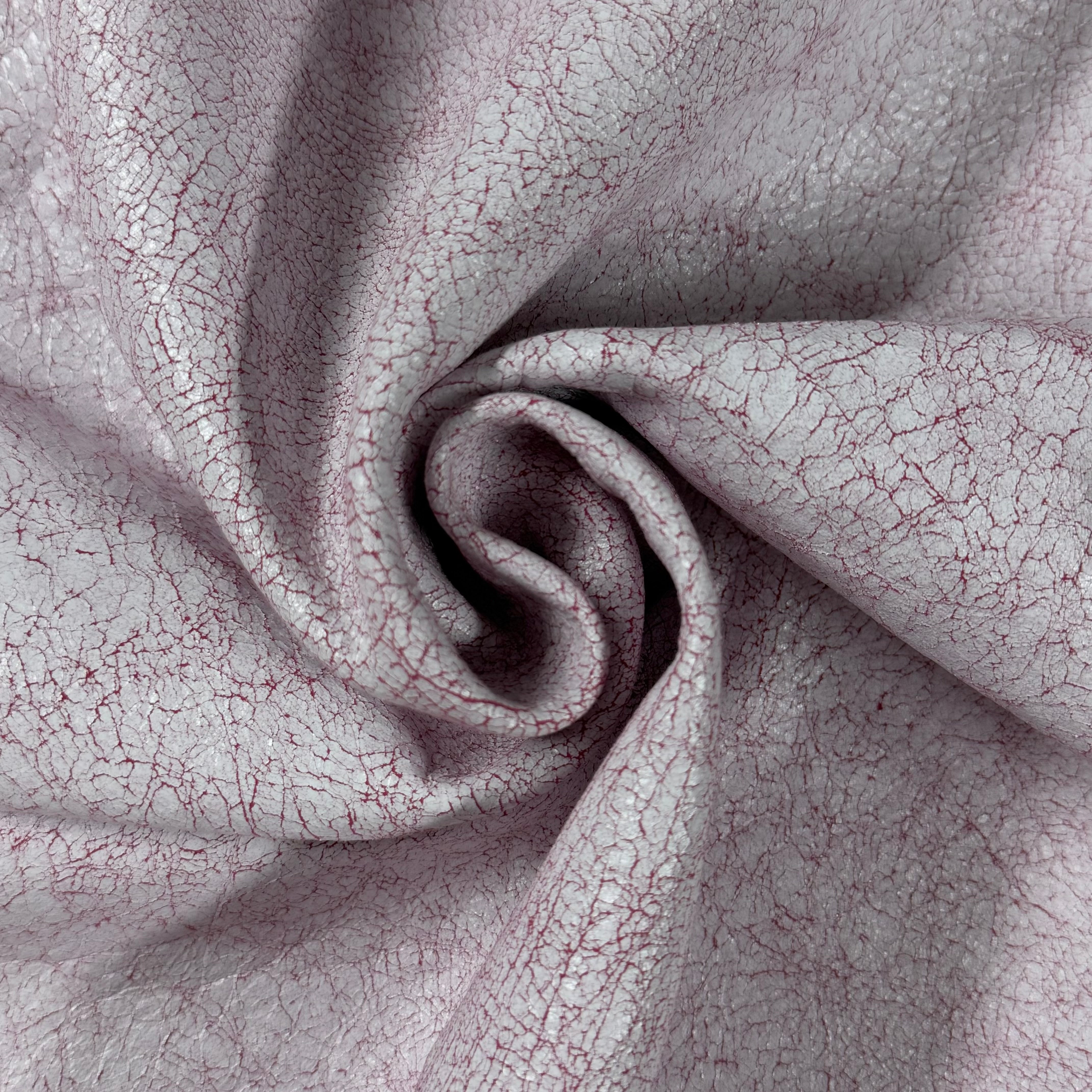 Crackle Leather in light pink with a distinct, textured distressed finish and deep red veining in a soft swirl.