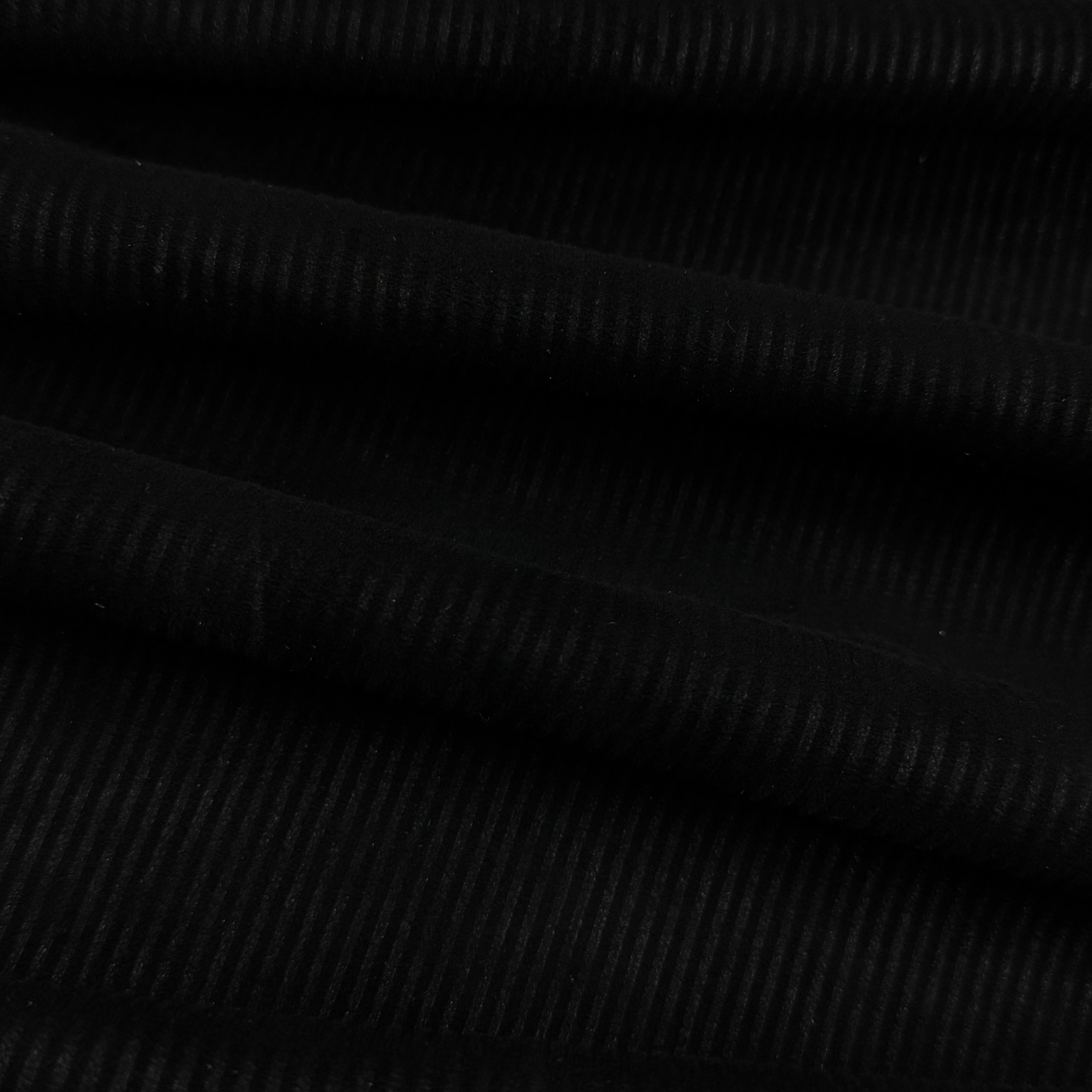 Black Corduroy Metis Lamb Suede fabric, showing ribbed texture and soft folds.