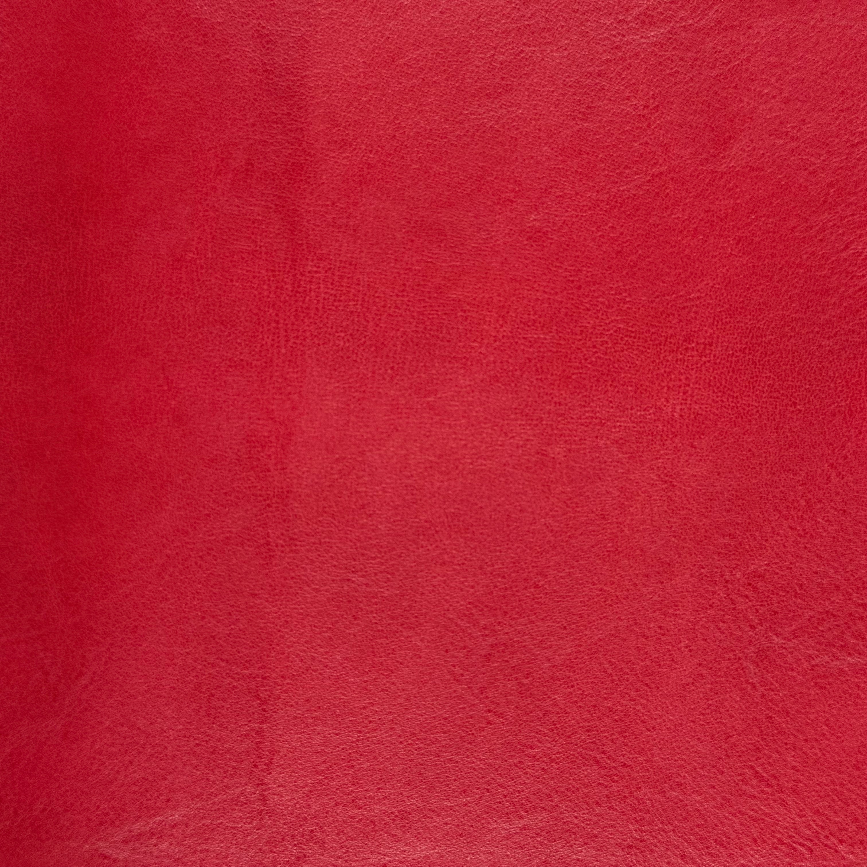 Smooth red vegetable-tanned baby calf leather with a polished aniline finish and subtle natural texture.