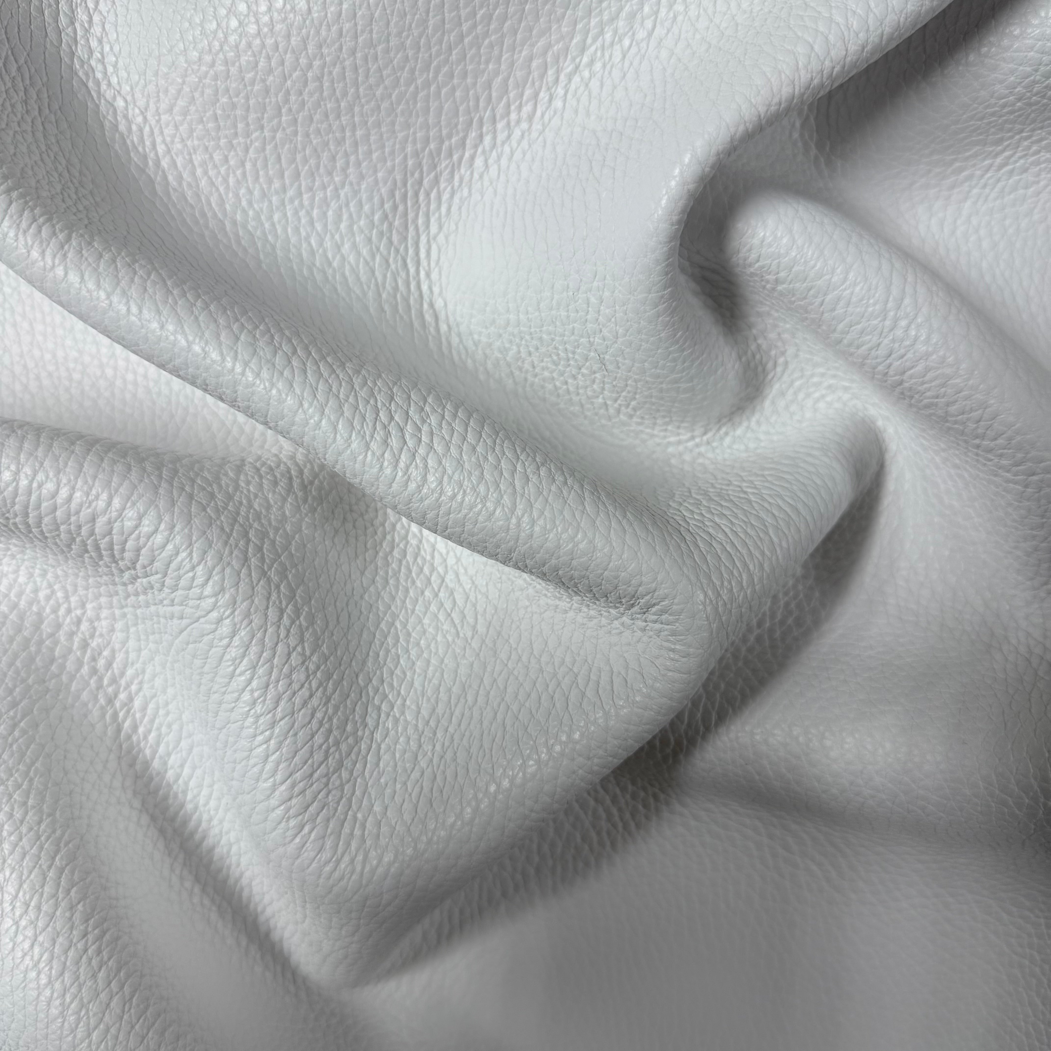 White Pebble Grain Calf leather, 3-4 oz weight, featuring a soft, textured surface with natural folds and draping.