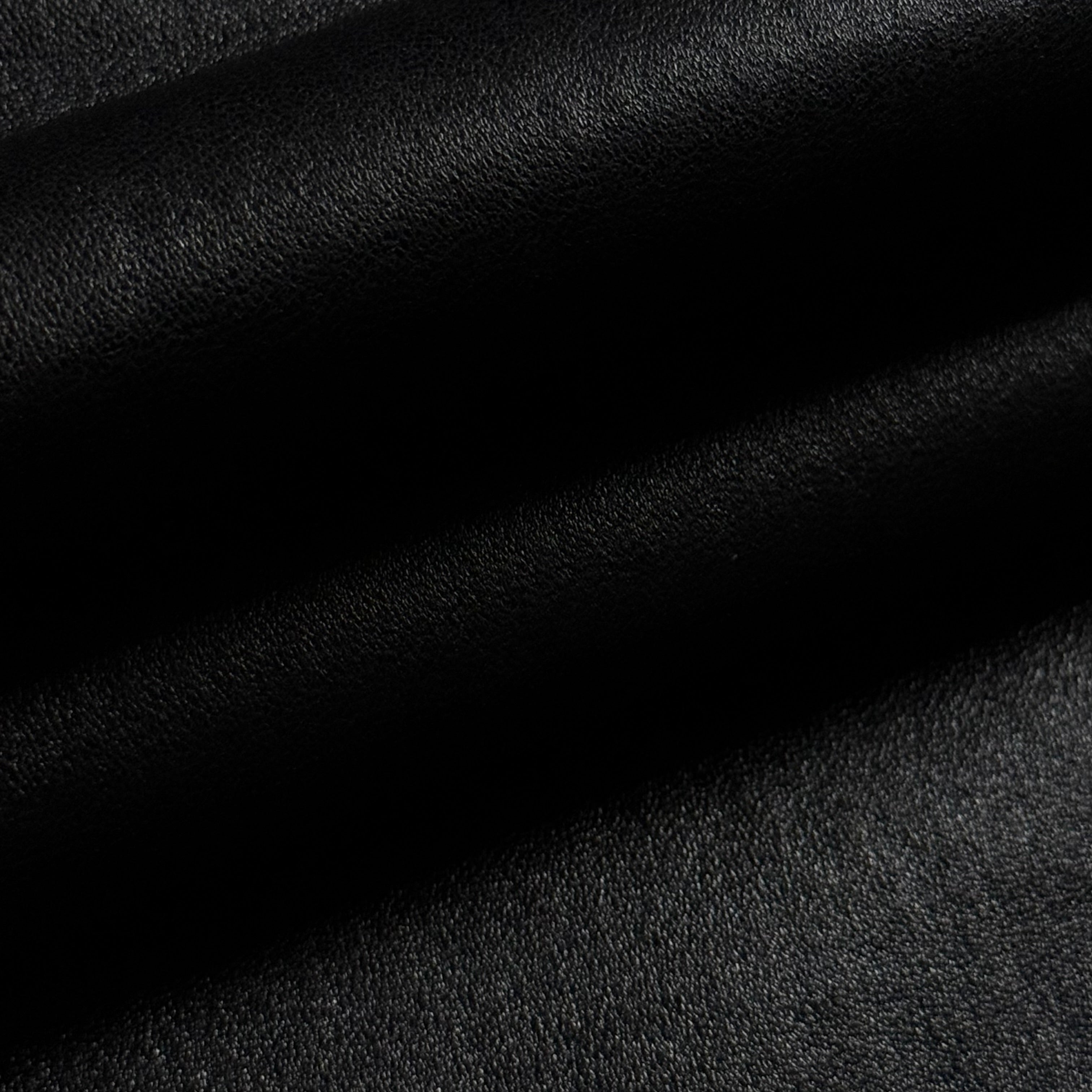Black Italian stretch nappa lamb leather, smooth with a slight sheen and soft folds.