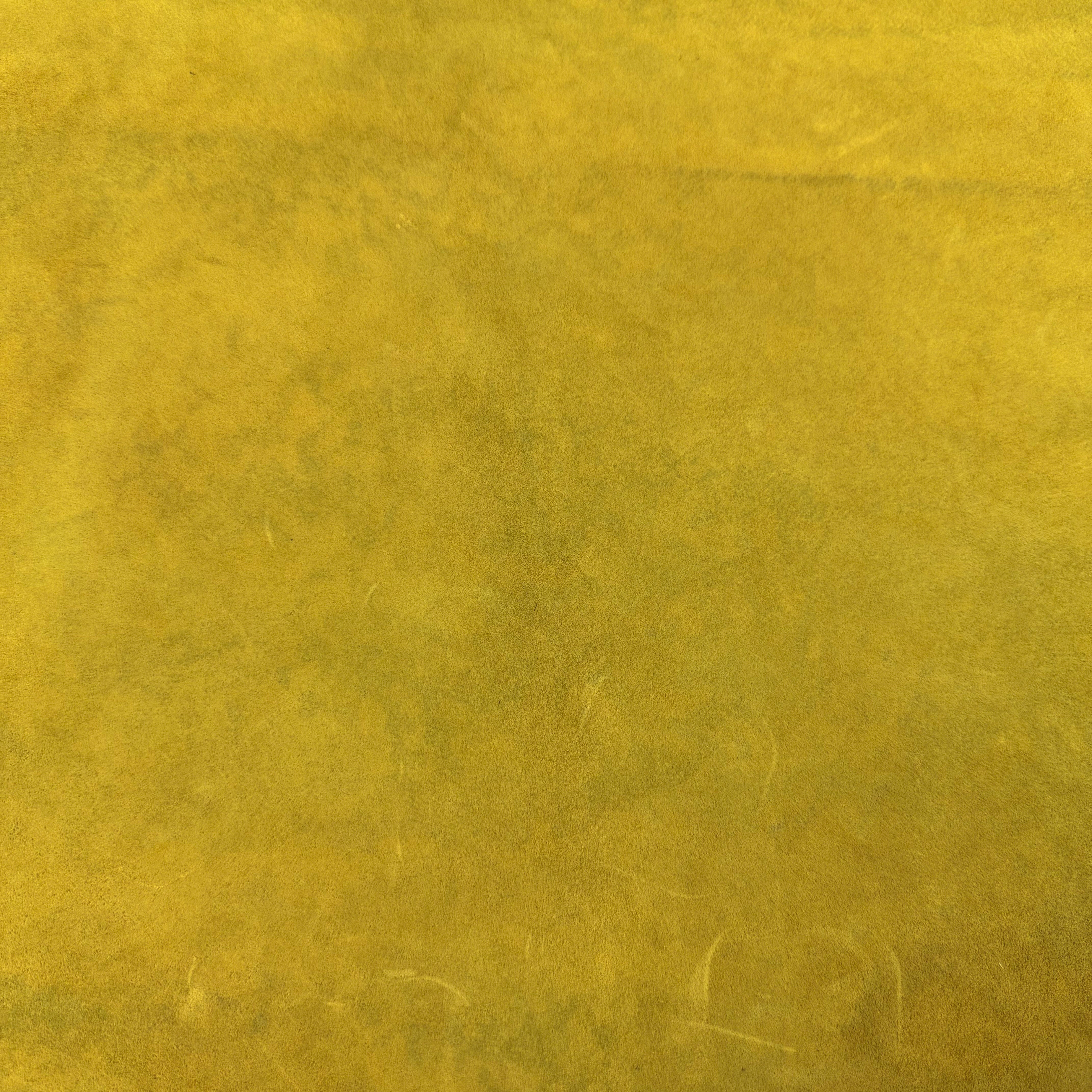 Close-up of a vibrant yellow Conceria Incas Italian Water Calf leather hide with a soft, suede-like finish.
